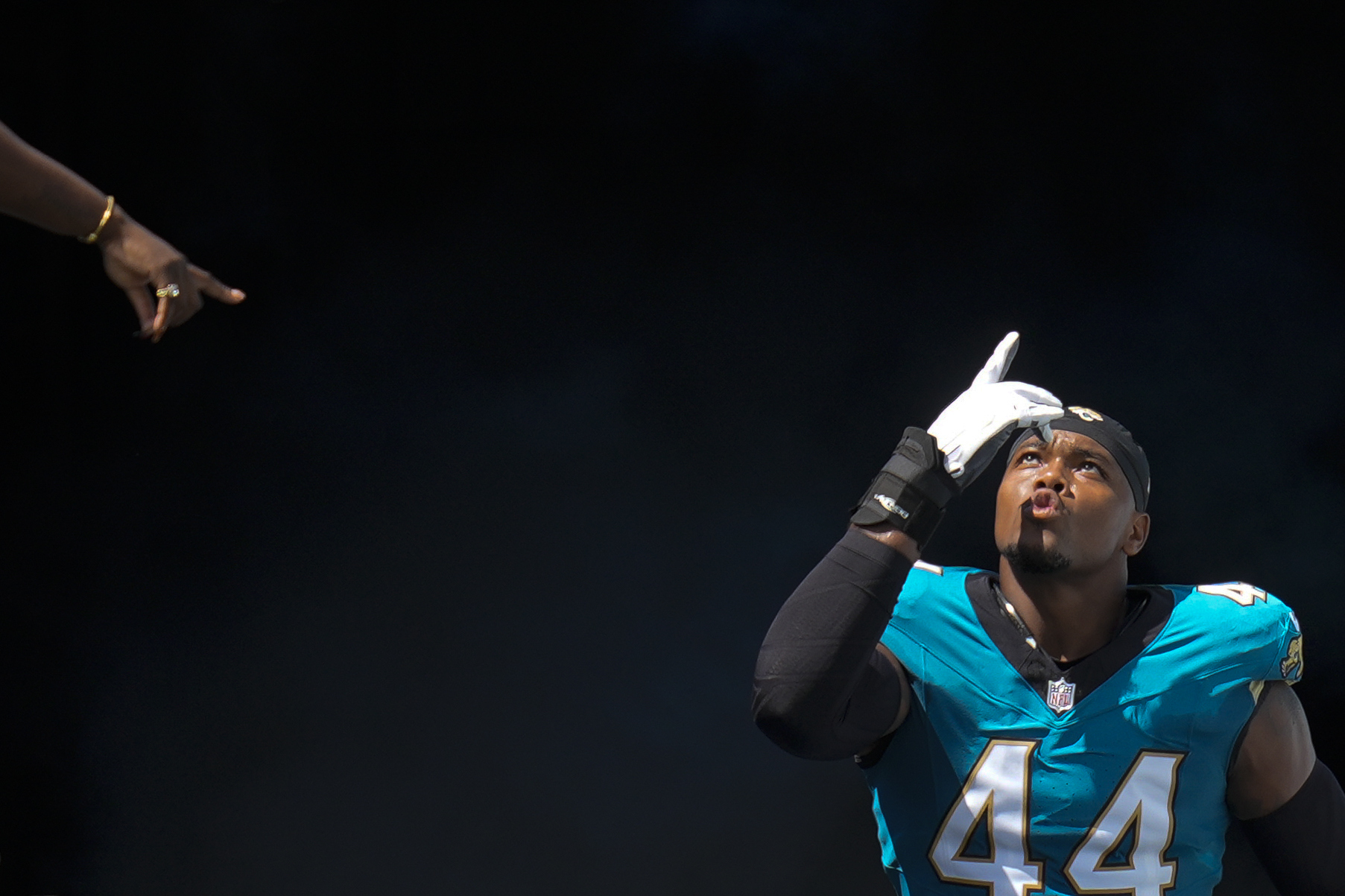 A spectator gestures as Jacksonville Jaguars defensive end Travon Walker is introduced onto the field prior to an NFL football game against the Houston Texans Sunday, Sept. 21, 2025, in Jacksonville, Fla. (John Raoux - AP)