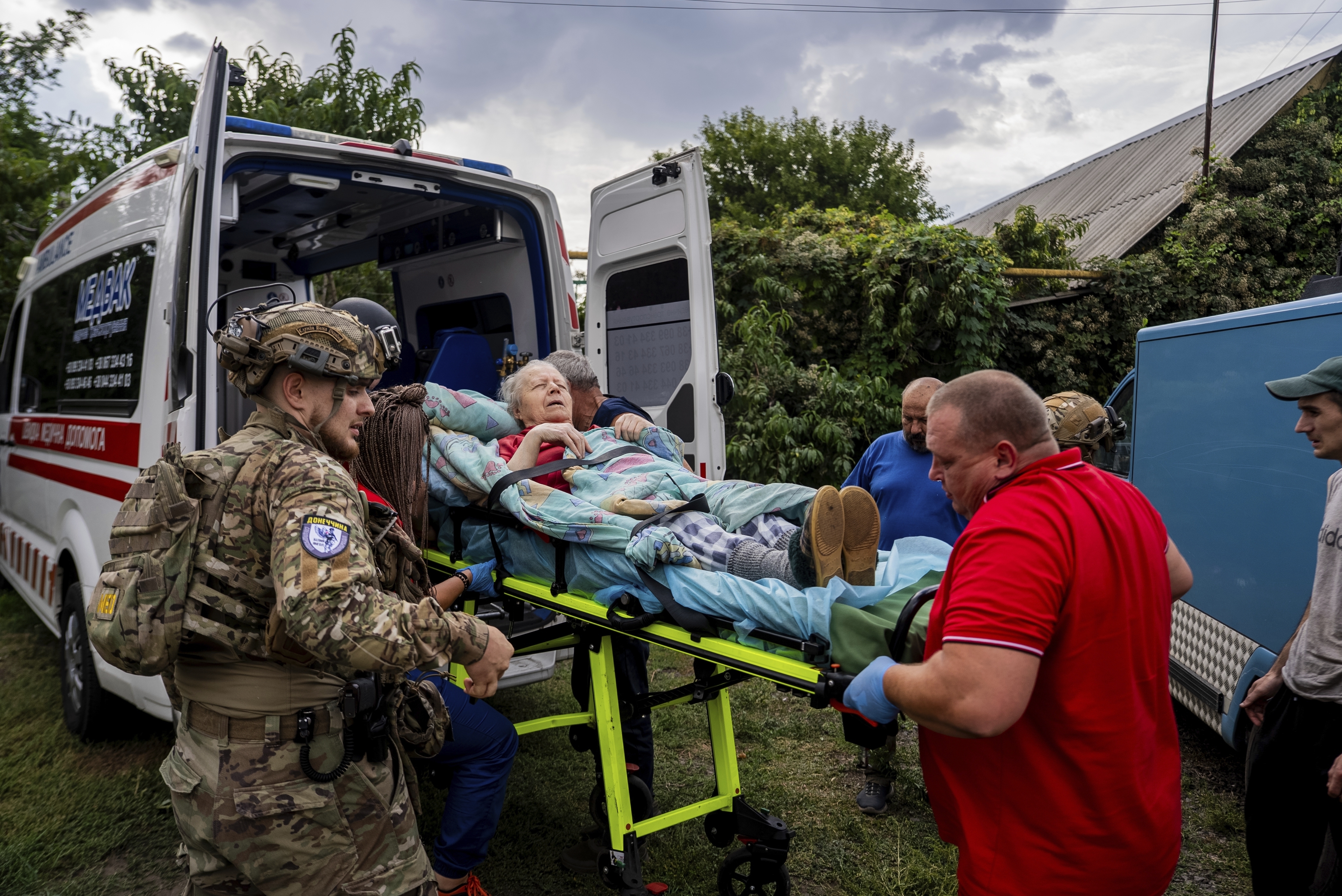 Policemen and medics transfer to the ambulance Olha Trush, 86 from the village of Yarova, that was hit by Russian aerial strike, which killed dozens of civilians, in Sloviansk, Donetsk region, Tuesday, Sept.9, 2025. (Alex Babenko - AP)