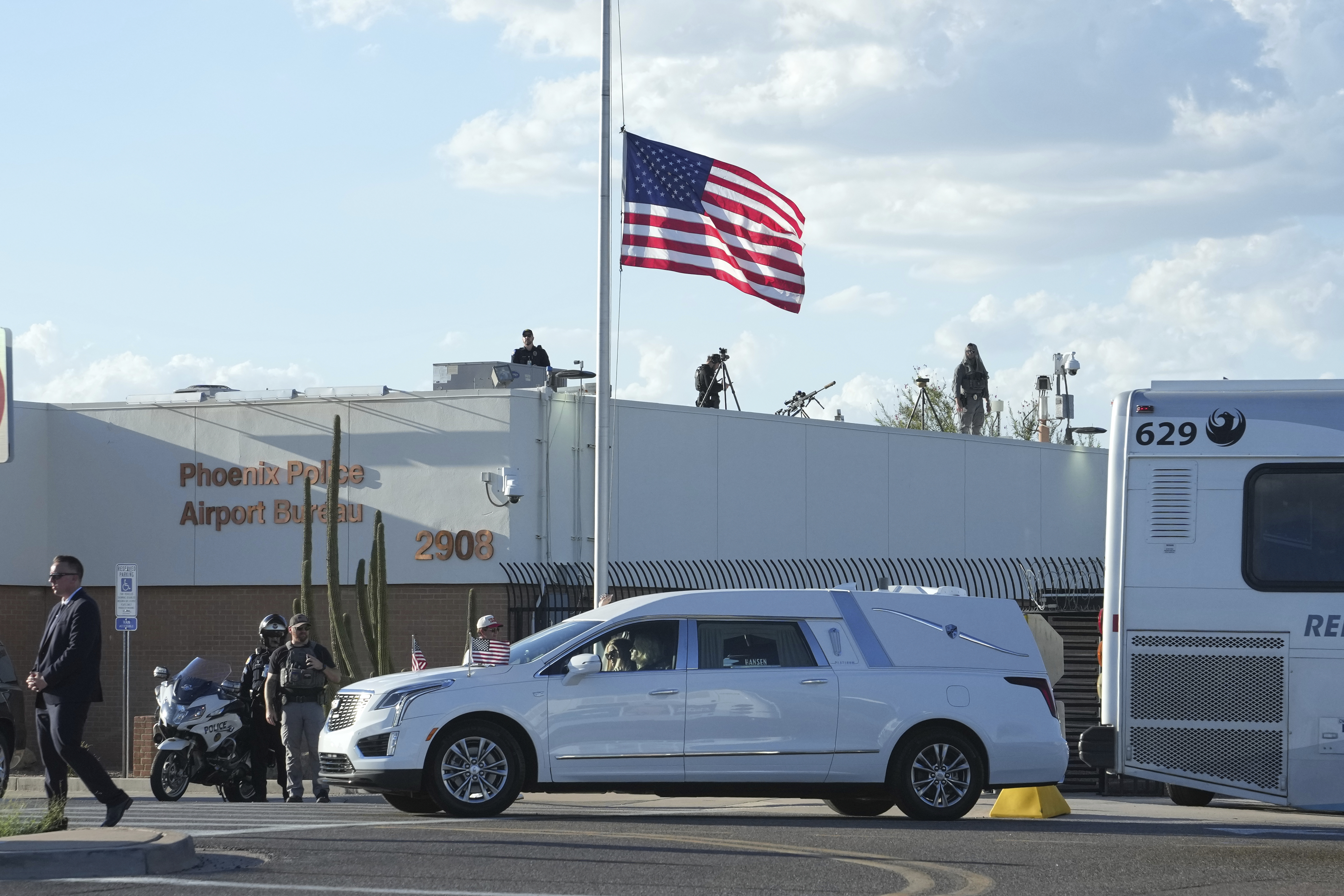 A hearse containing the body of Charlie Kirk, the CEO and co-founder of Turning Point USA who was shot and killed on Wednesday leaves after being removed from Air Force Two at Phoenix Sky Harbor International Airport, Thursday, Sept. 11, 2025, in Phoenix. (Ross D. Franklin - AP)