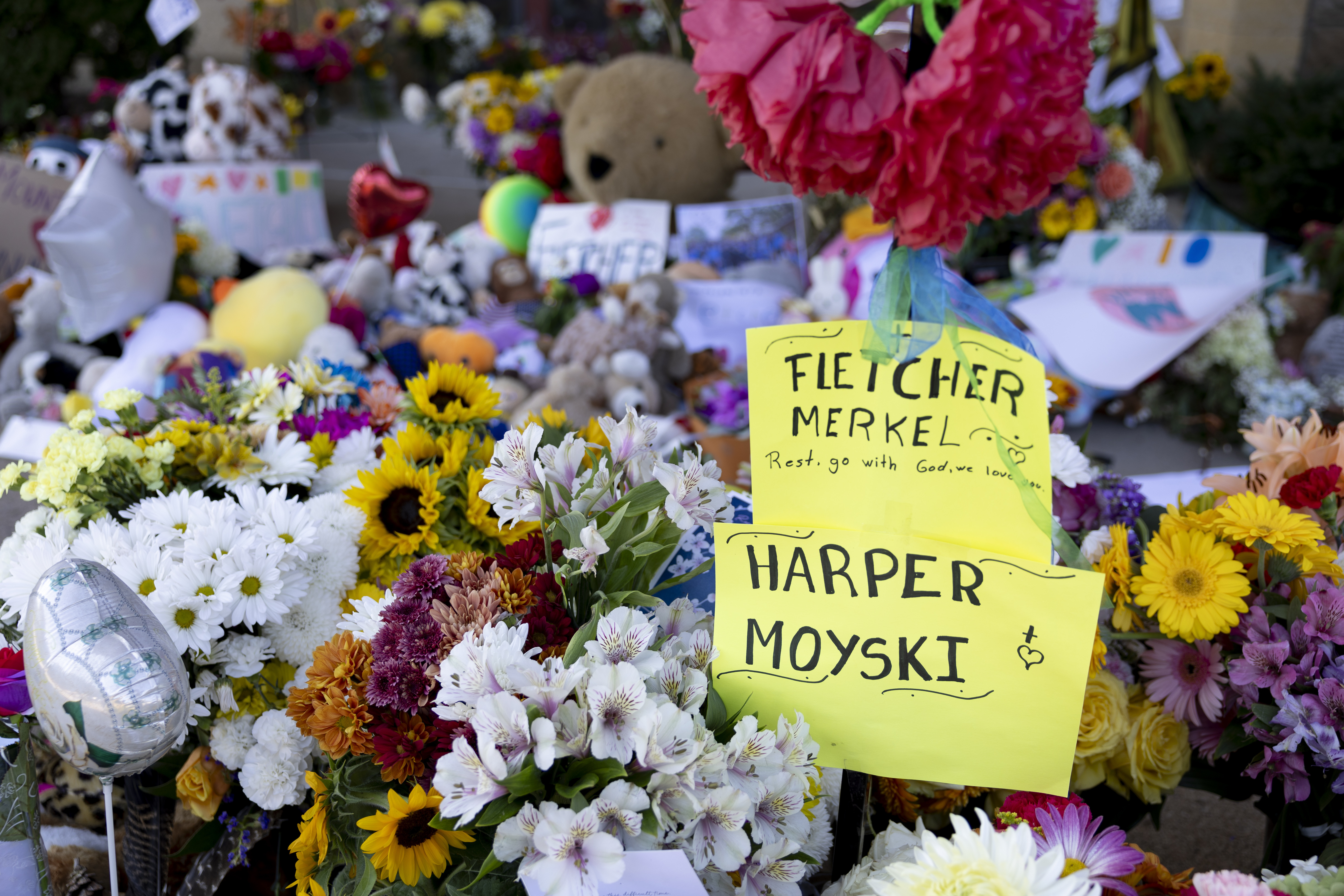 FILE - A sign honors the two victims who died in Wednesday's shooting, 8-year-old Fletcher Merkel and 10-year-old Harper Moyski, outside Annunciation Catholic Church, Aug. 31, 2025, in Minneapolis. (Ellen Schmidt - FR171854 AP)