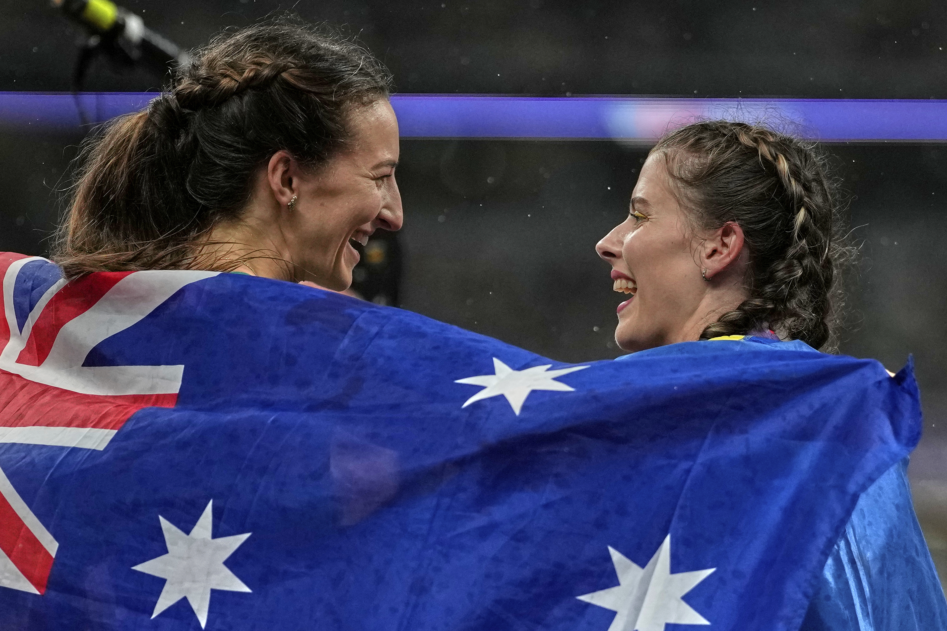 Australia's Nicola Olyslagers, gold, celebrates with Ukraine's Yaroslava Mahuchikhn after the women's high jump final at the World Athletics Championships in Tokyo, Sunday, Sept. 21, 2025. (Louise Delmotte - AP)