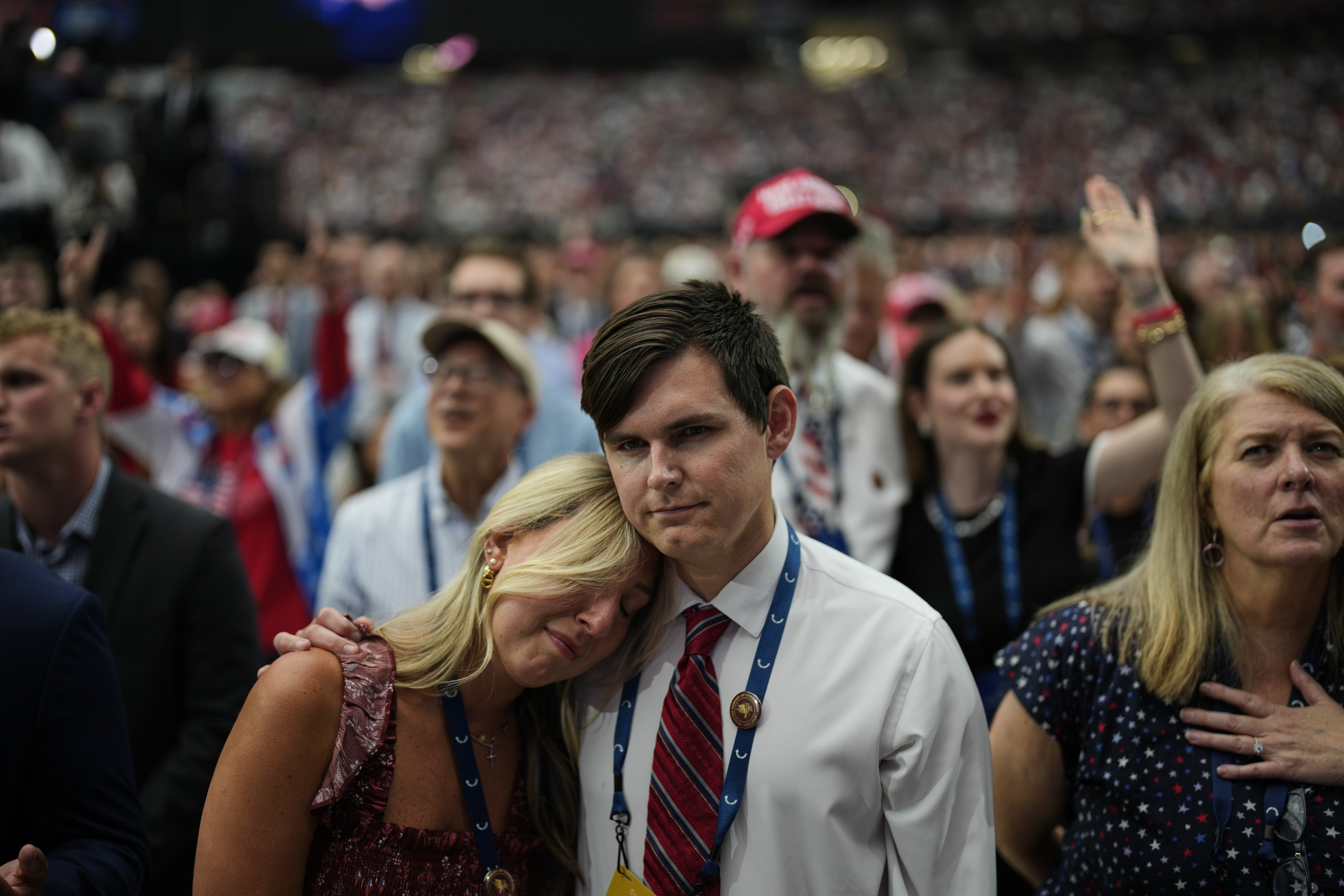 A woman is overcome with emotion while watching a Charlie Kirk tribute video during a memorial for the conservative activist Sunday, Sept. 21, 2025, at State Farm Stadium in Glendale, Ariz. (John Locher - AP)