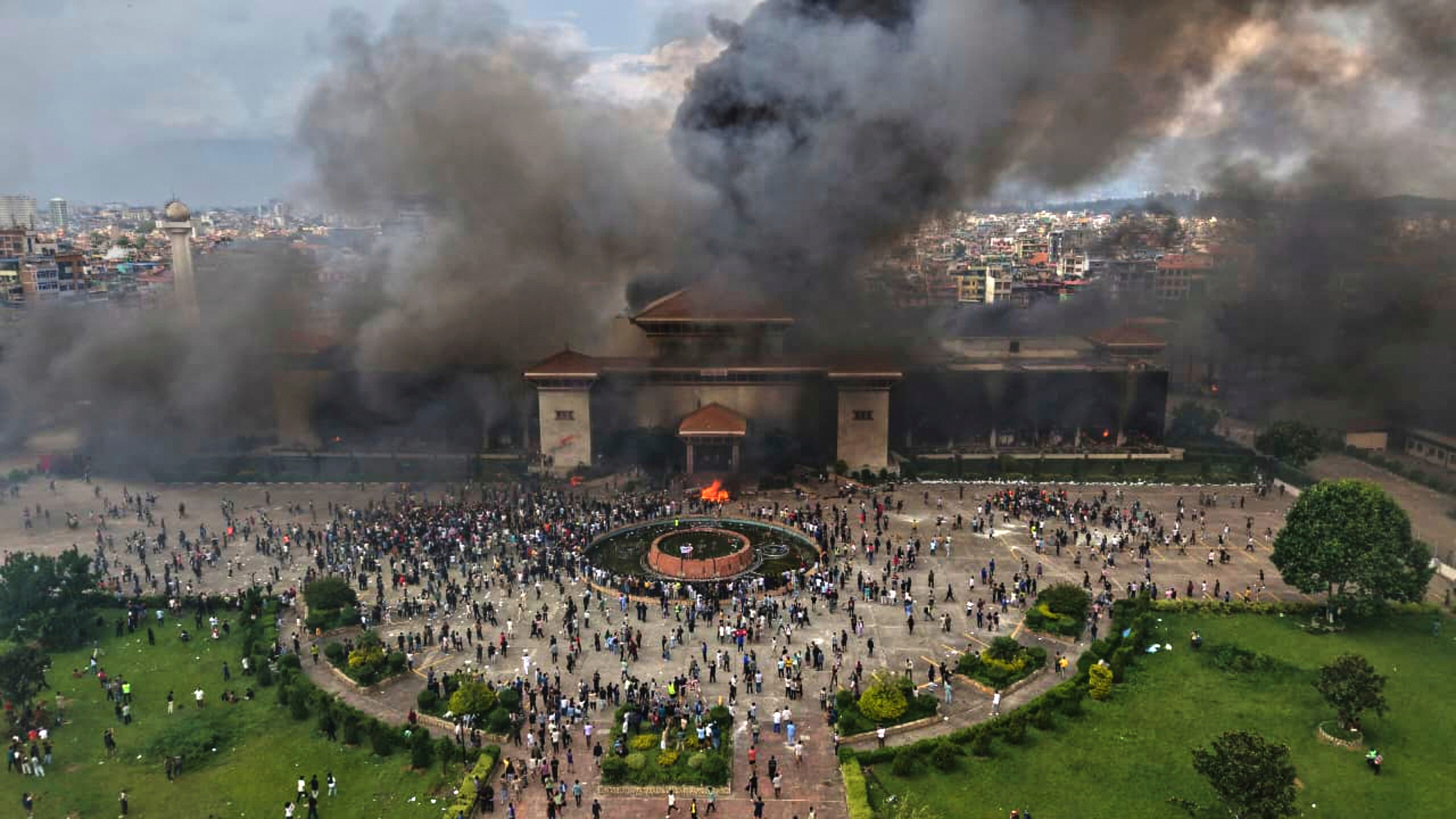 Protesters celebrate at the parliament building after it was set on fire during a protest against social media ban and corruption in Kathmandu, Nepal, Tuesday, Sept. 9, 2025. (Prakash Timalsina - AP)