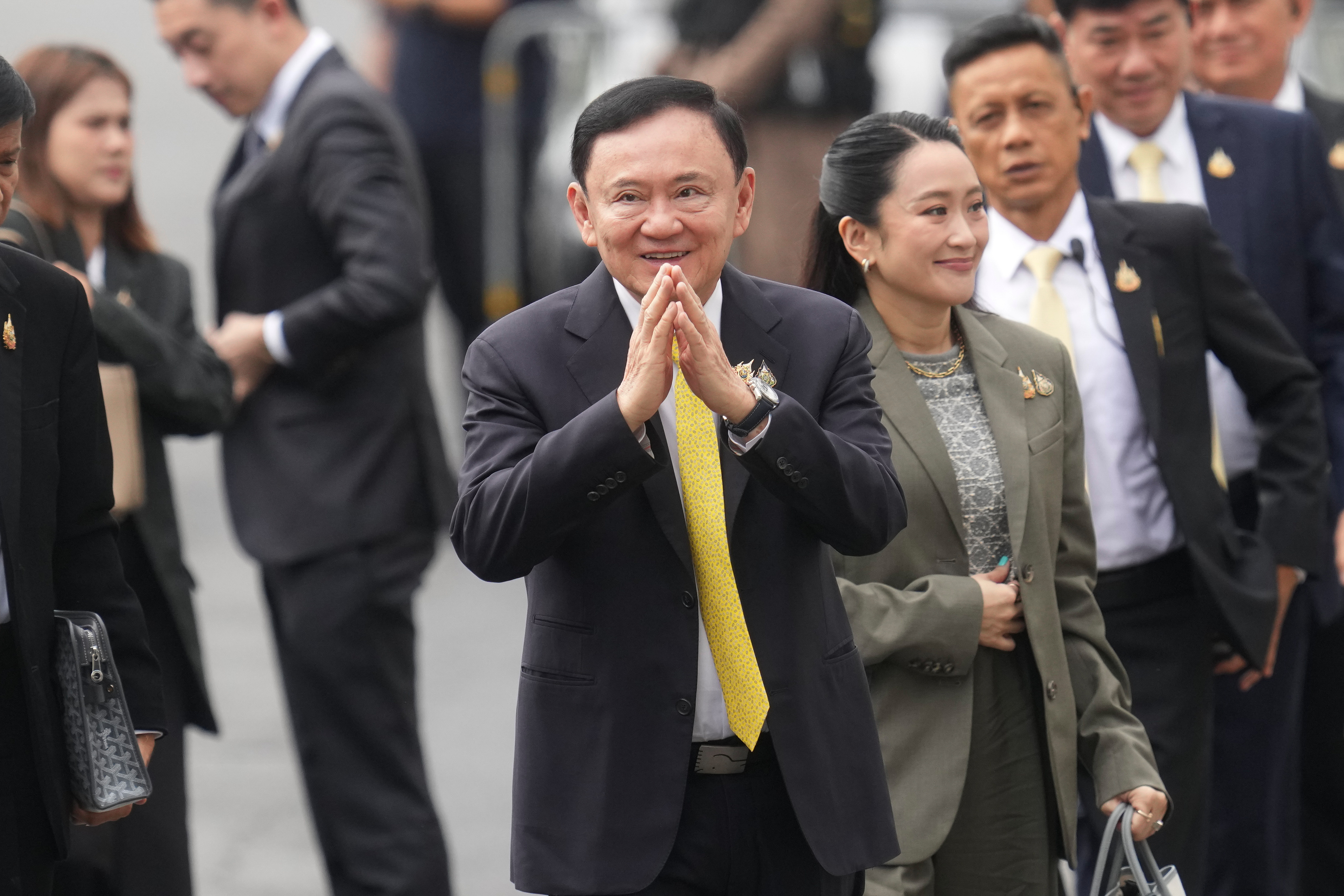 Thailand's former Prime Minister Thaksin Shinawatra, center, and his daughter and former Prime Minister Paetongtarn Shinawatra, right, arrive at Supreme Court in Bangkok, Thailand, Tuesday, Sept. 9, 2025. (Sakchai Lait - AP)