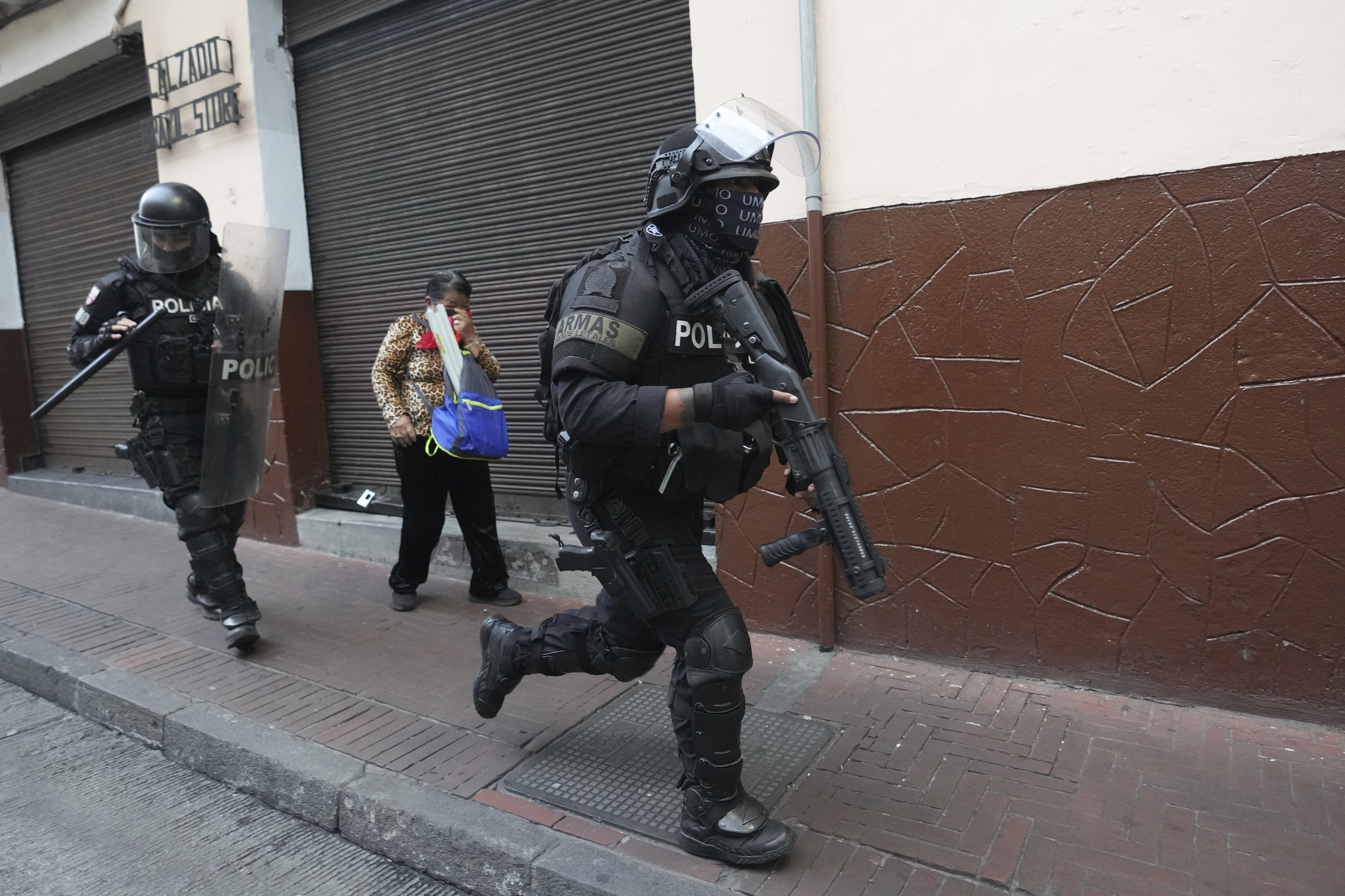 Police officers run during protests, after President Daniel Noboa eliminated the diesel subsidy in Quito, Ecuador, Tuesday, Sept. 16, 2025. (Dolores Ochoa - AP)