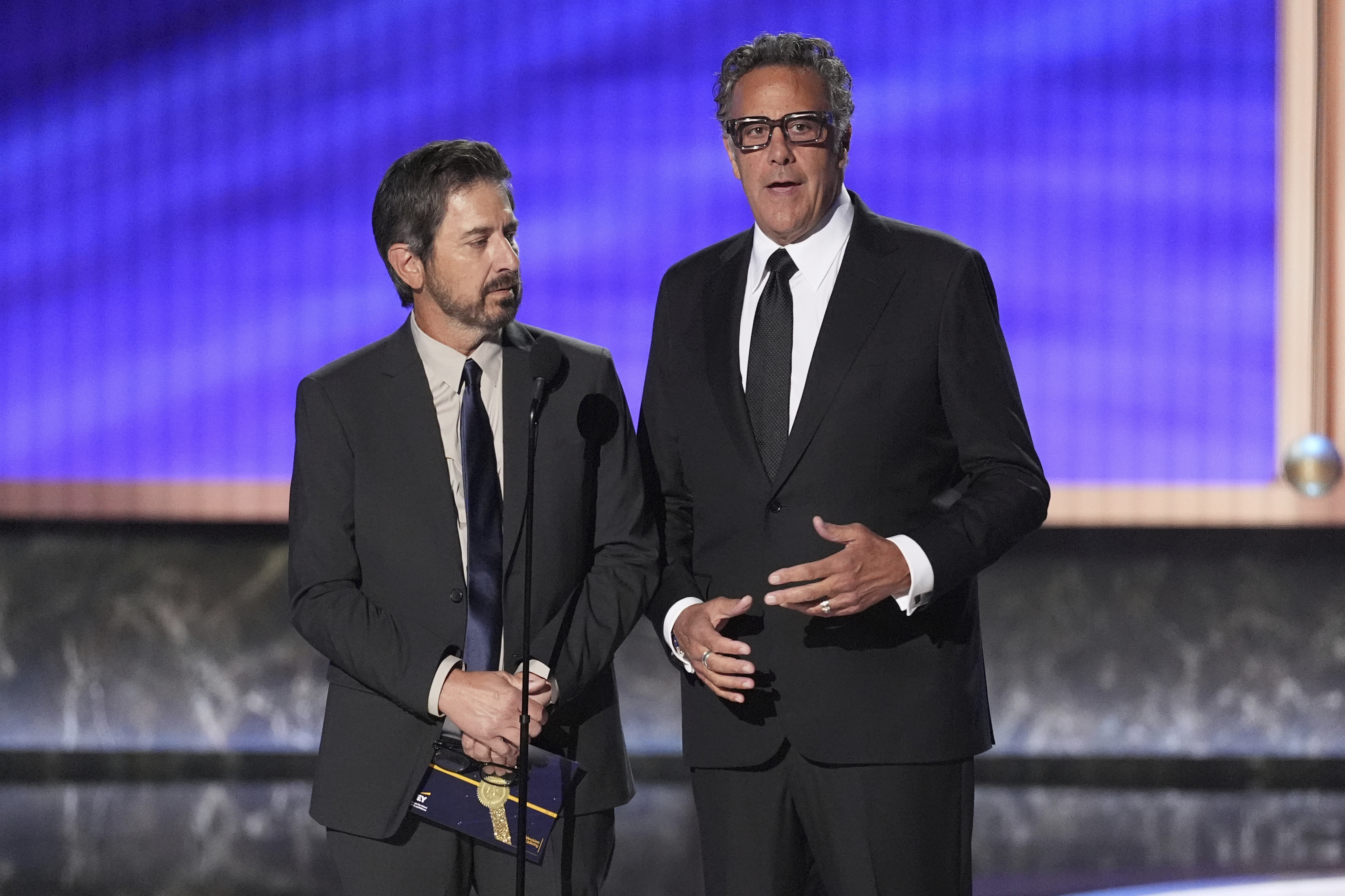 Ray Romano, left, and Brad Garrett present the award for outstanding comedy series during the 77th Primetime Emmy Awards on Sunday, Sept. 14, 2025, at the Peacock Theater in Los Angeles. (Chris Pizzello - Invision)
