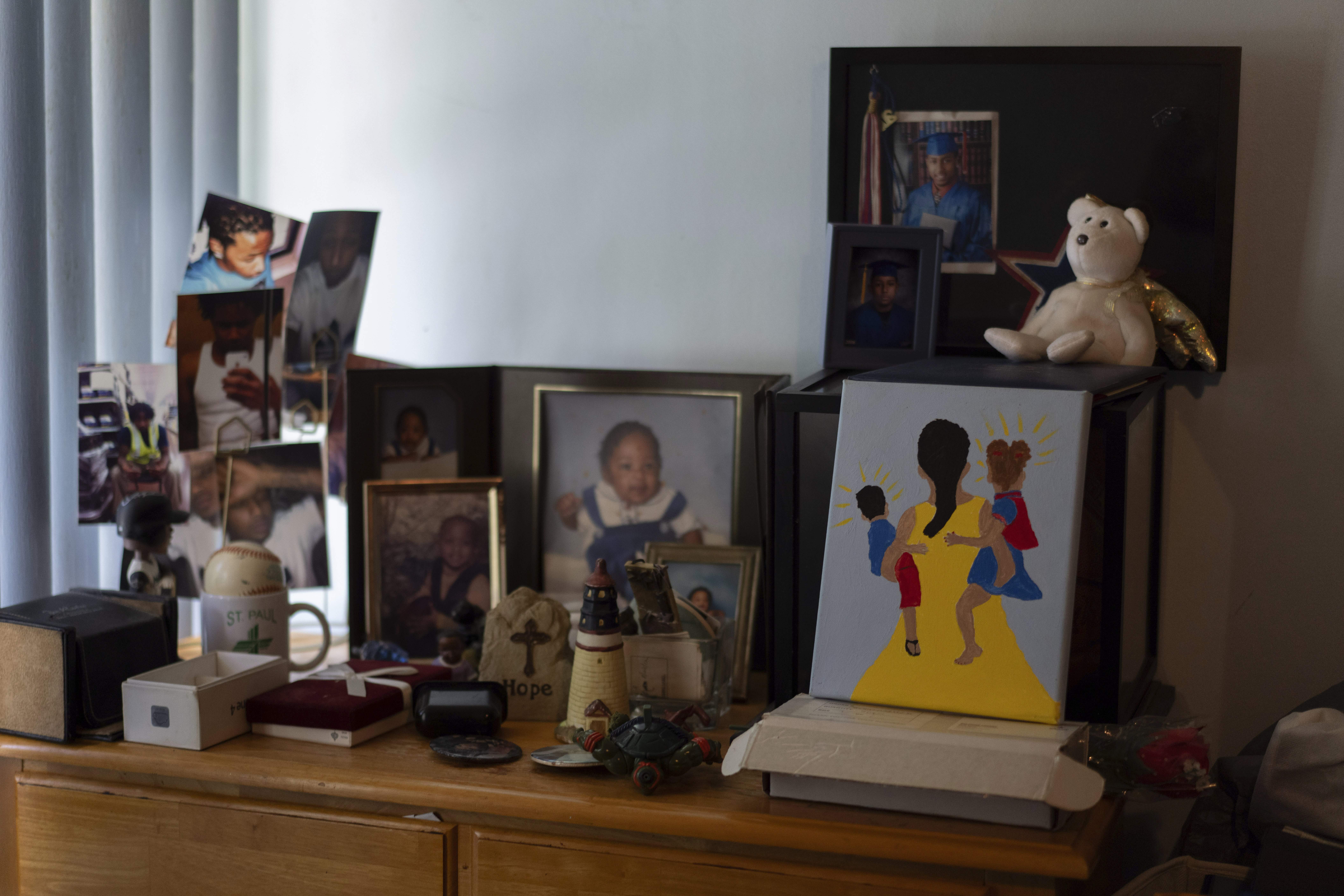 Delphine Cherry's photos of her son, Tyler Randolph, and a painting she made of a mother holding two children sit on a dresser in her home Friday, Sept. 5, 2025, in Hazel Crest, Ill. (Carolyn Kaster - AP)