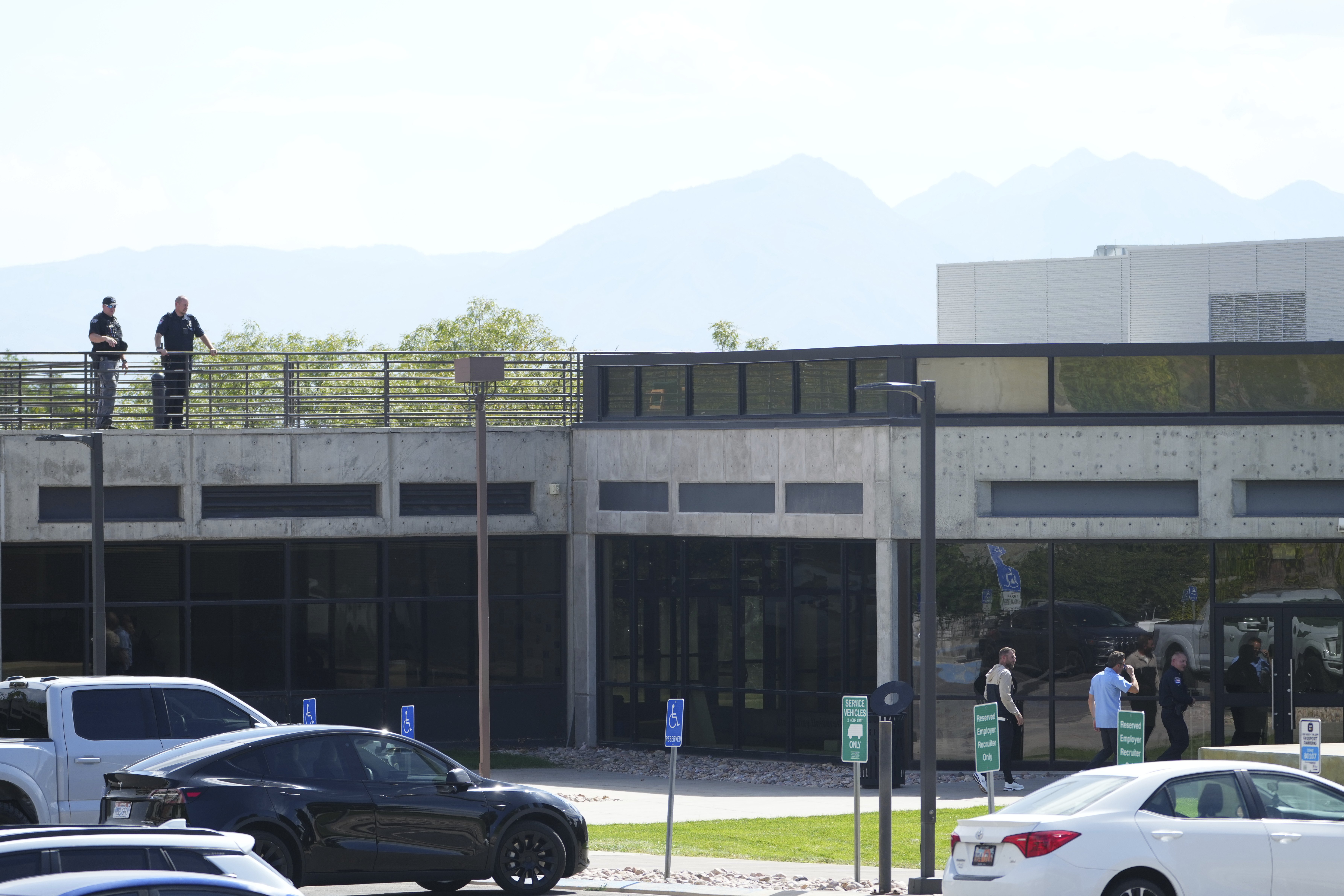 Law enforcement stands at the top of the Losee Center, where the alleged gunman used to escape from the roof after shooting and killing Turning Point USA CEO and co-founder Charlie Kirk, at Utah Valley University, Friday, Sept. 12, 2025, in Orem, Utah. (Lindsey Wasson - AP)