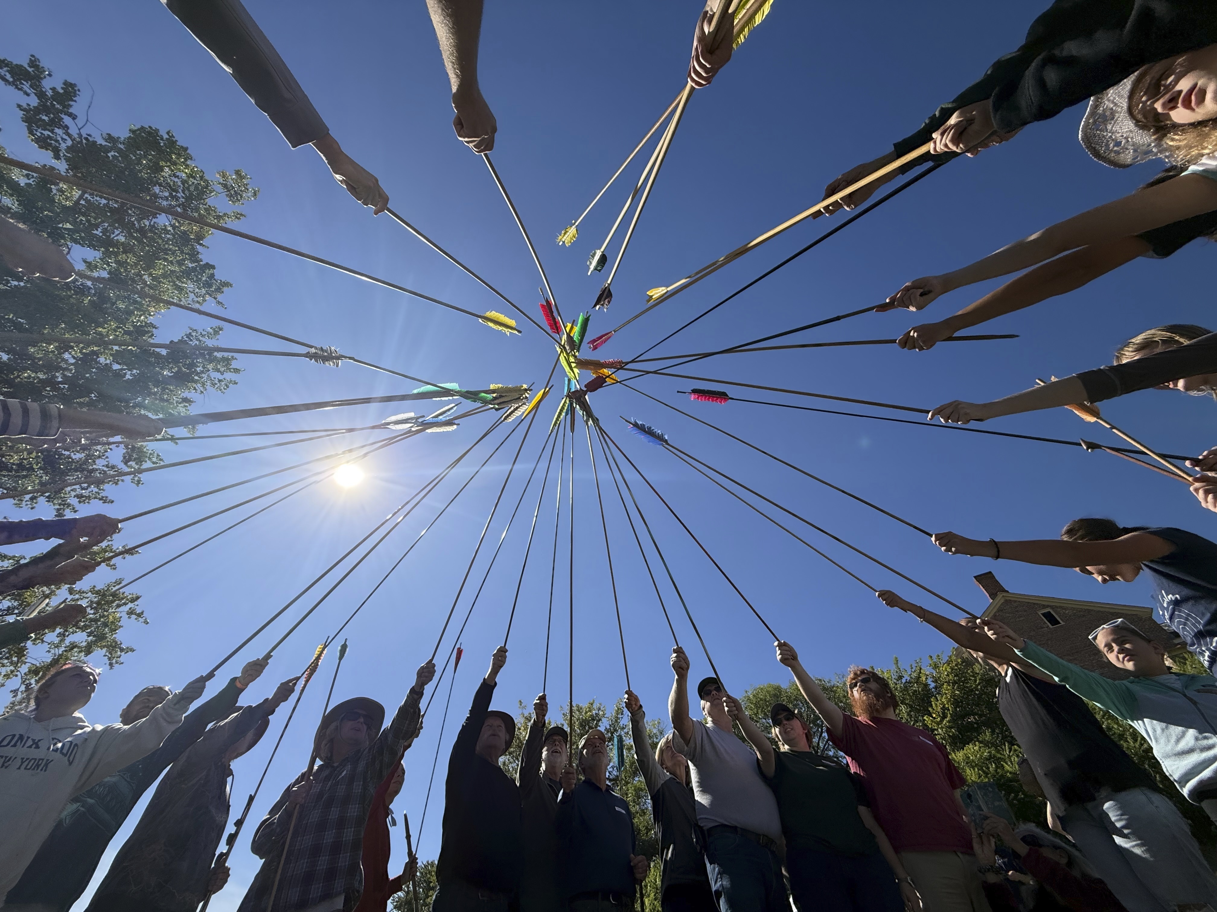 Competitors raise their darts as part of the opening ceremony for the Northeastern Atlatl Championship in Addison, Vt., Saturday, Sept. 20, 2025. (Amanda Swinhart - AP)