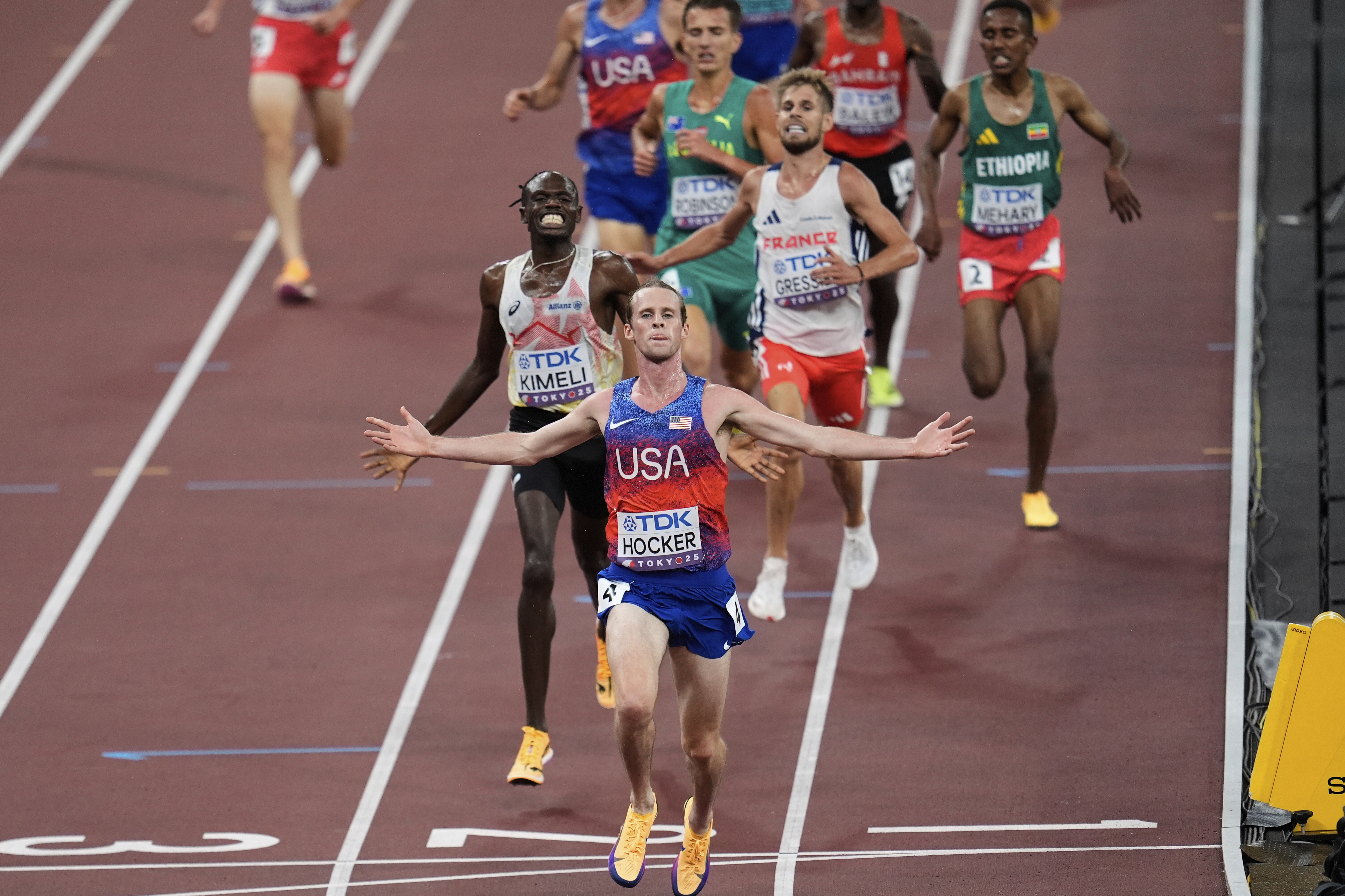 United States' Cole Hocker crosses the finish line before Belgium's Isaac Kimeli in the men's 5,000 meters final at the World Athletics Championships in Tokyo, Sunday, Sept. 21, 2025. (Abbie Parr - AP)