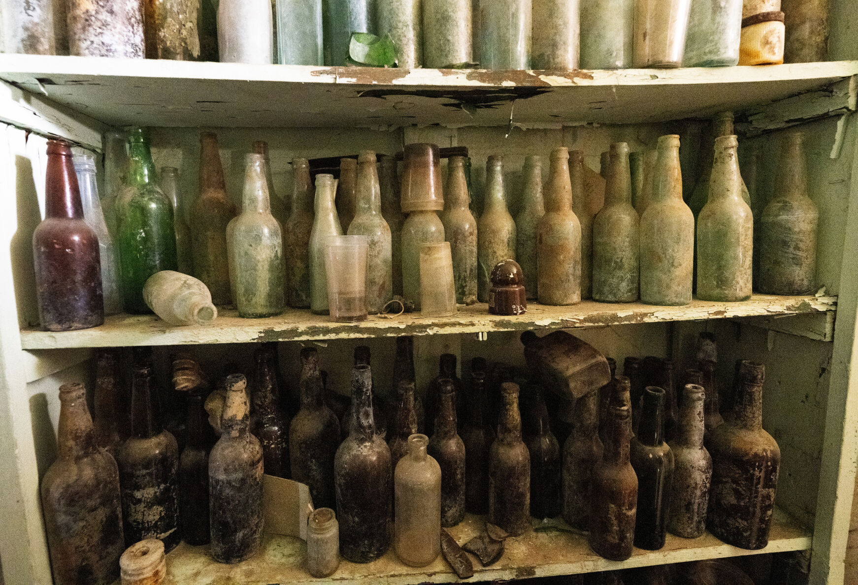 Old bottles line the shelves in a room at the World’s Wonder View Tower last month outside Genoa, Colo. (Christian Murdock, The Gazette)