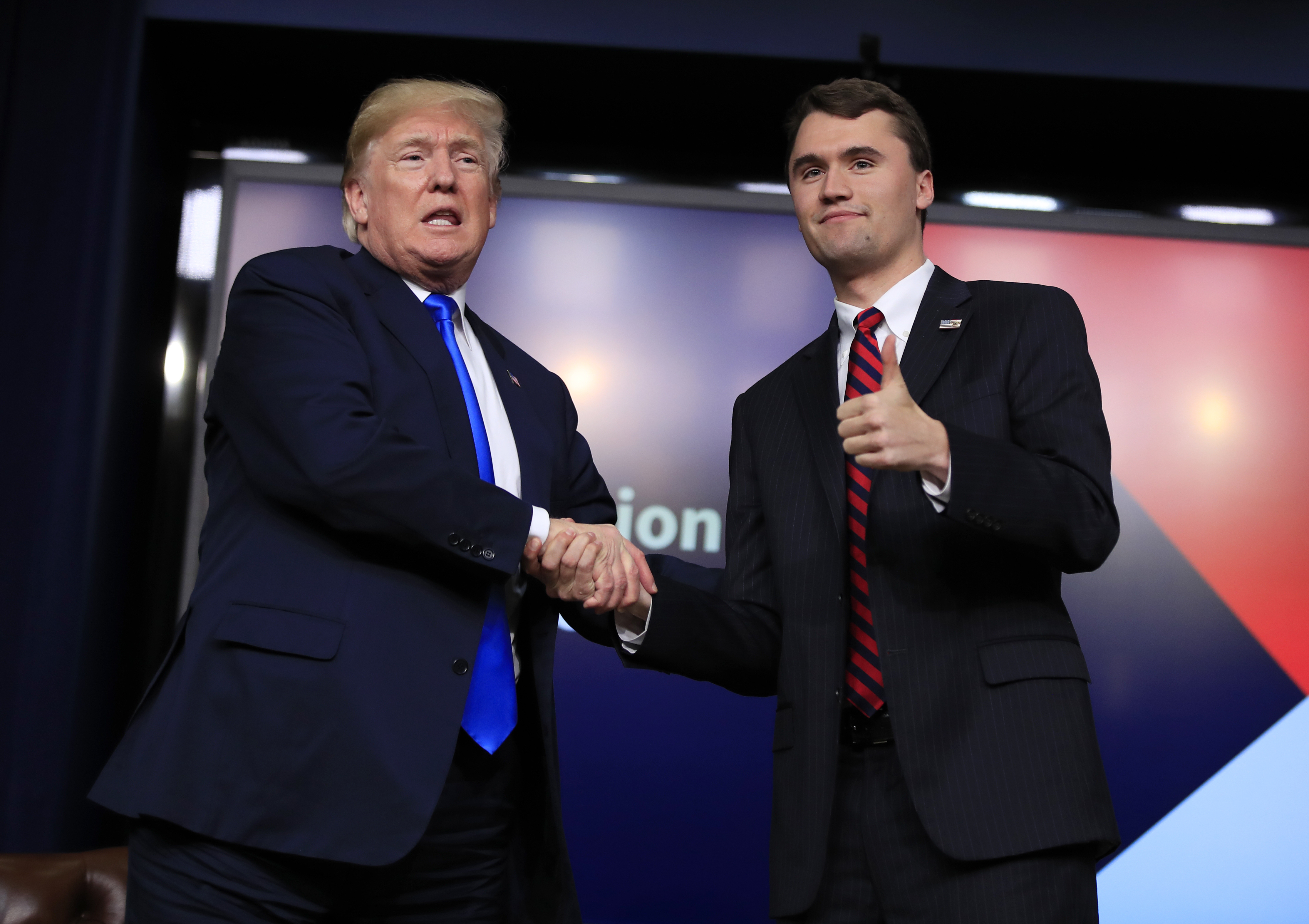 FILE - President Donald Trump shakes hands with moderator Charlie Kirk, during a Generation Next White House forum at the Eisenhower Executive Office Building on the White House complex in Washington, Thursday, March 22, 2018. (Manuel Balce Ceneta - AP)