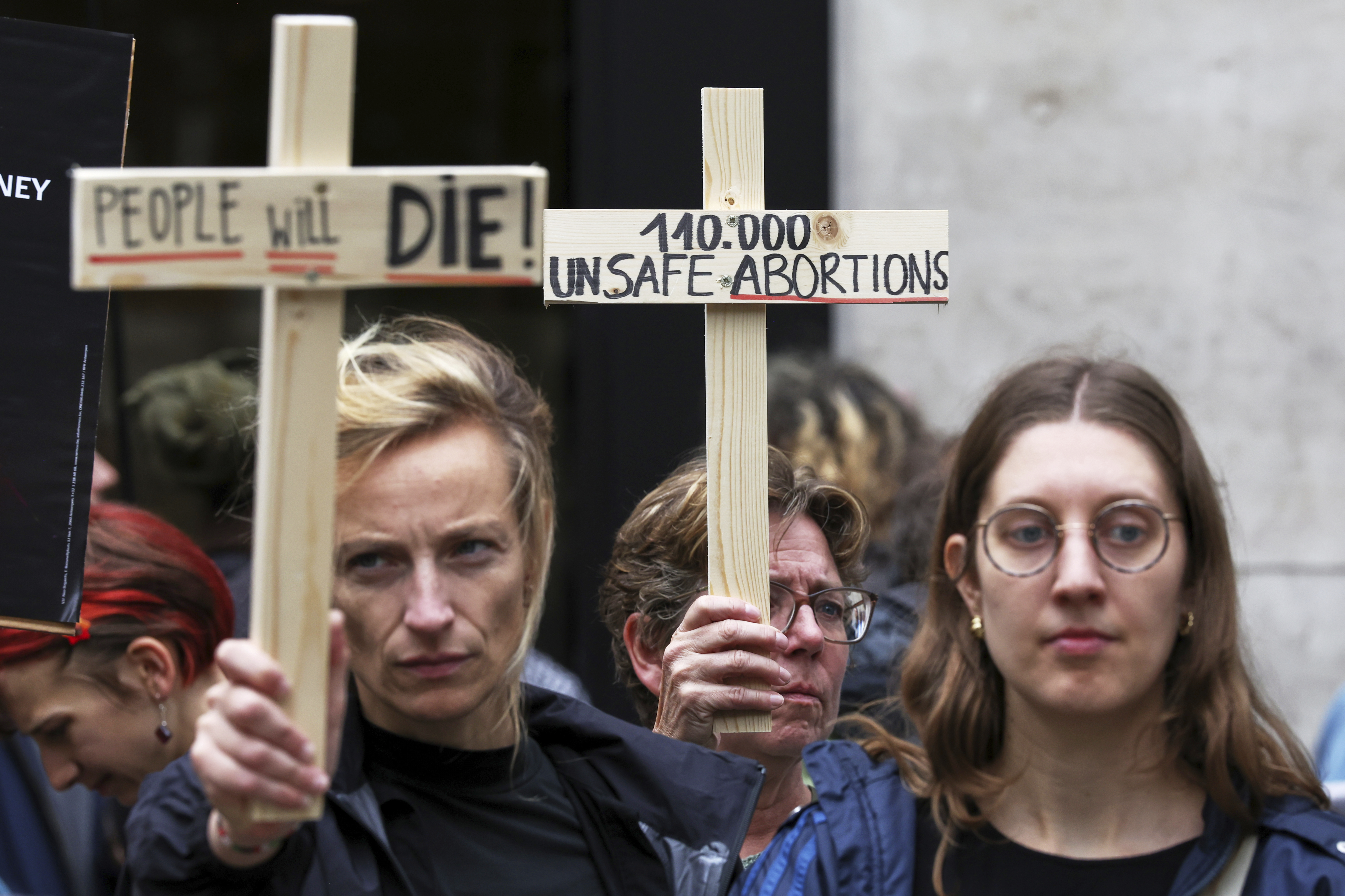Participants from various women's rights organizations hold signs as they demonstrate regarding the destruction of family planning supplies stockpiled in Belgium, near the U.S. embassy in Brussels, Thursday, Sept. 18, 2025. (Omar Havana - AP)