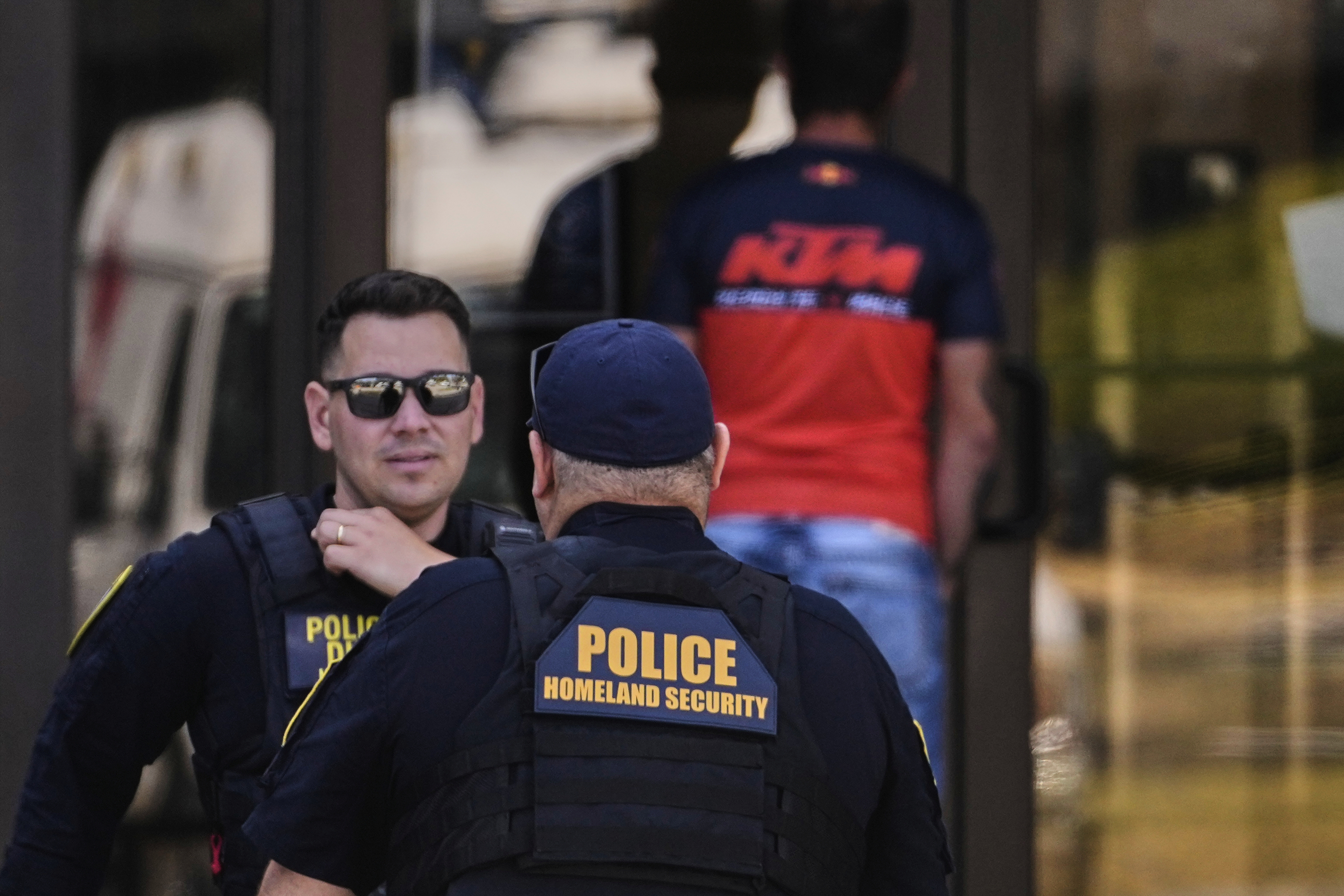 Department of Homeland Security police officers are stationed at the front door of the U.S. Immigration and Customs Enforcement regional field office, Tuesday, Sept. 16, 2025, in Burlington, Mass. (Charles Krupa - AP)
