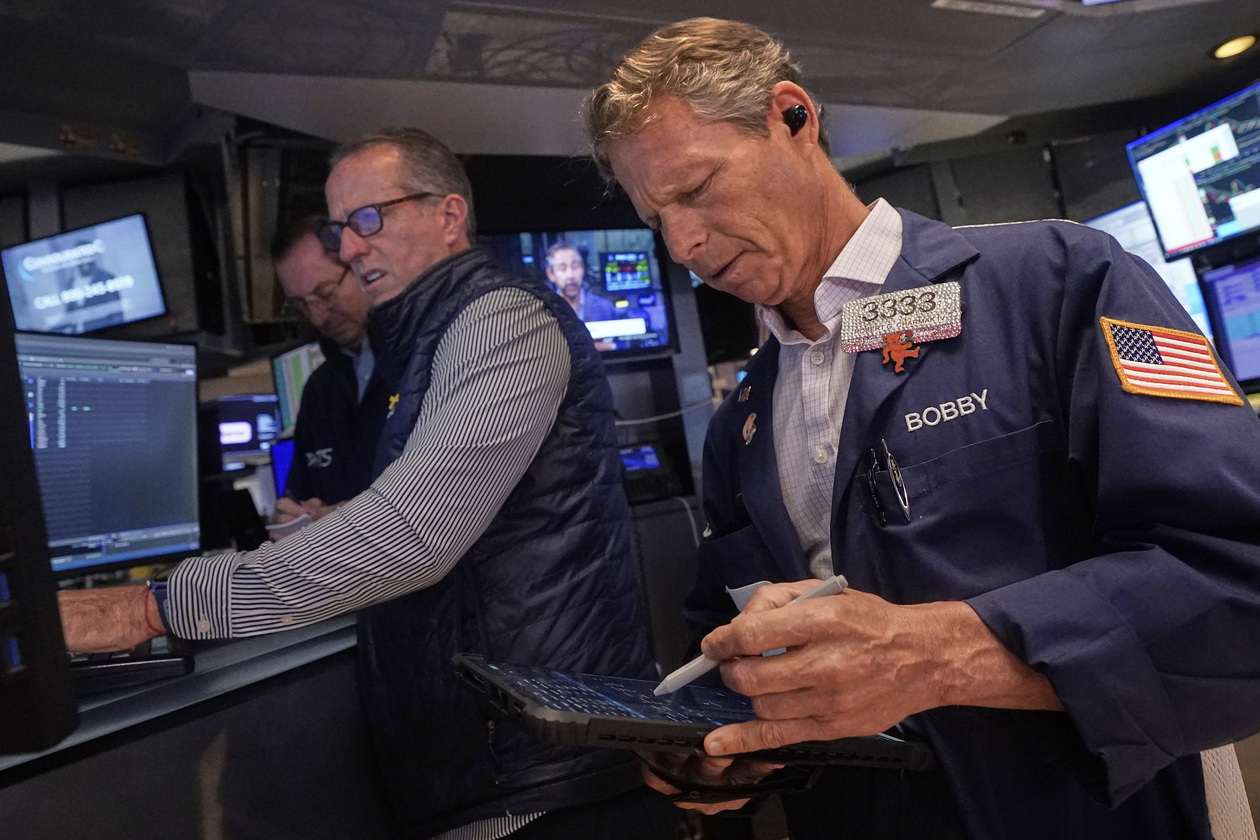 Trader Robert Charmak, right, and specialist Glenn Carell, center, work on the floor of the New York Stock Exchange, Wednesday, Sept. 10, 2025. (Richard Drew - AP)
