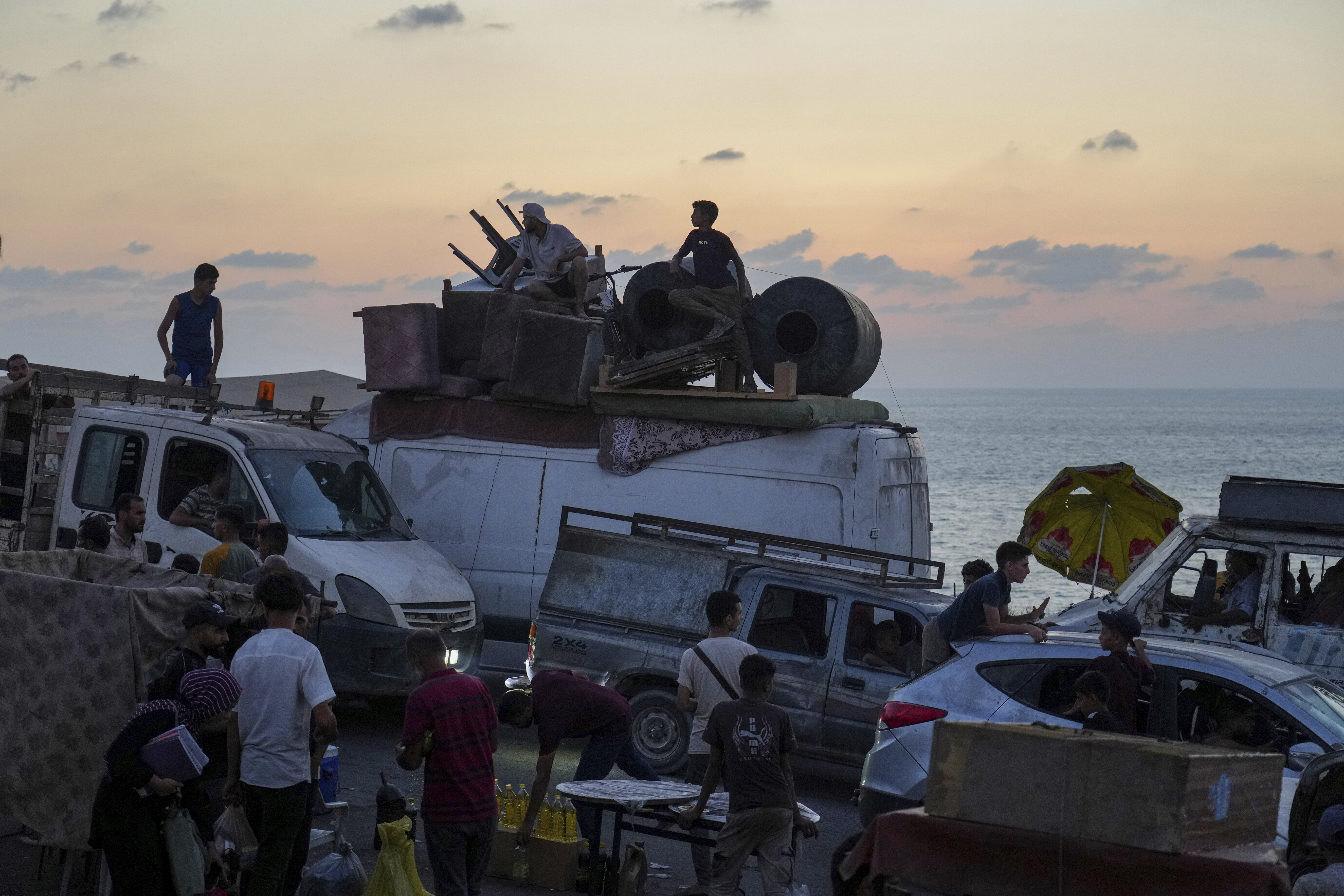 Displaced Palestinians fleeing northern Gaza carry their belongings along the coastal road toward southern Gaza ,Sunday, Sept. 7, 2025. (Jehad Alshrafi - AP)