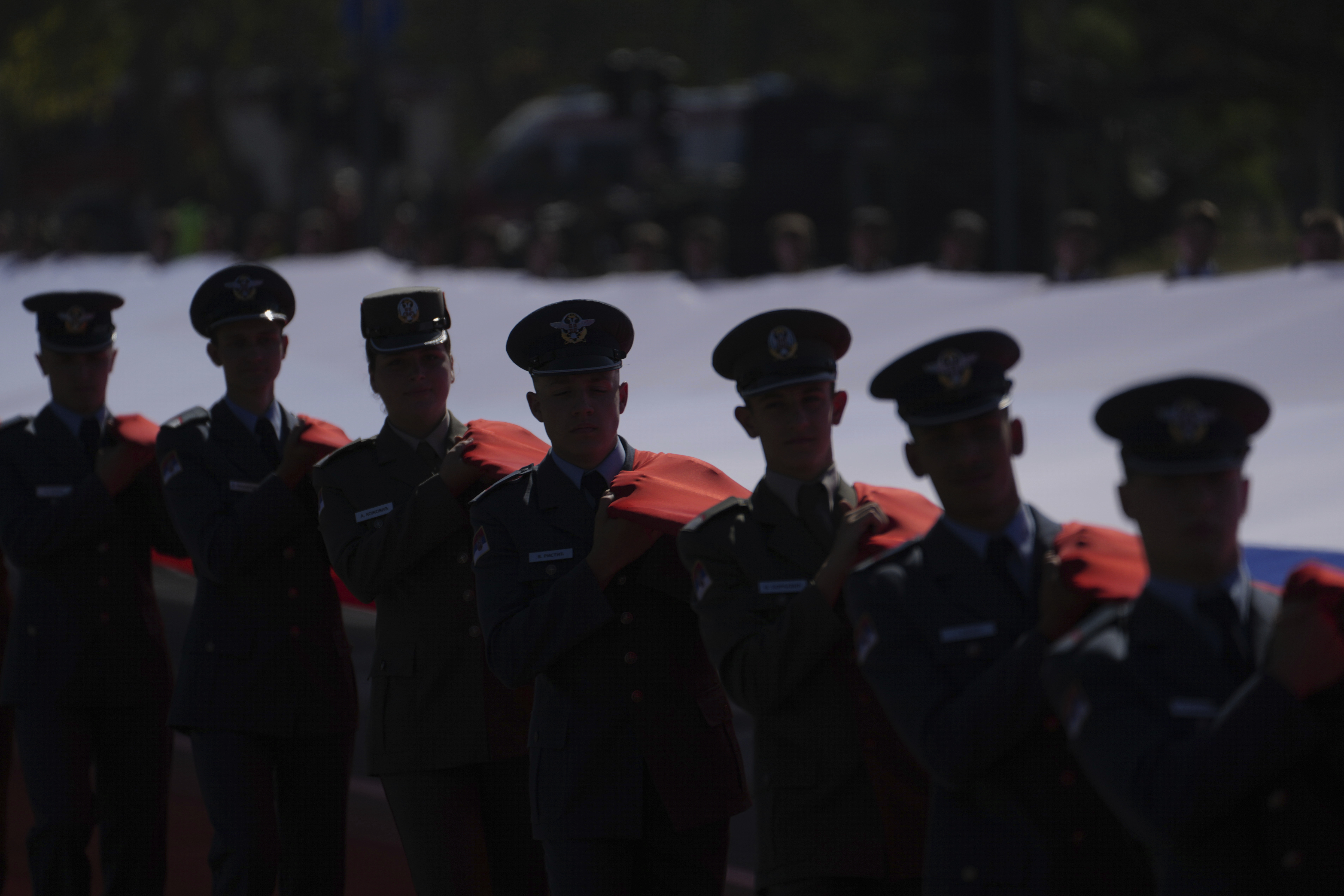 Serbian Army soldiers hold a giant Serbian flag during a military parade in Belgrade, Serbia, Saturday, Sept. 20, 2025. (Darko Vojinovic - AP)