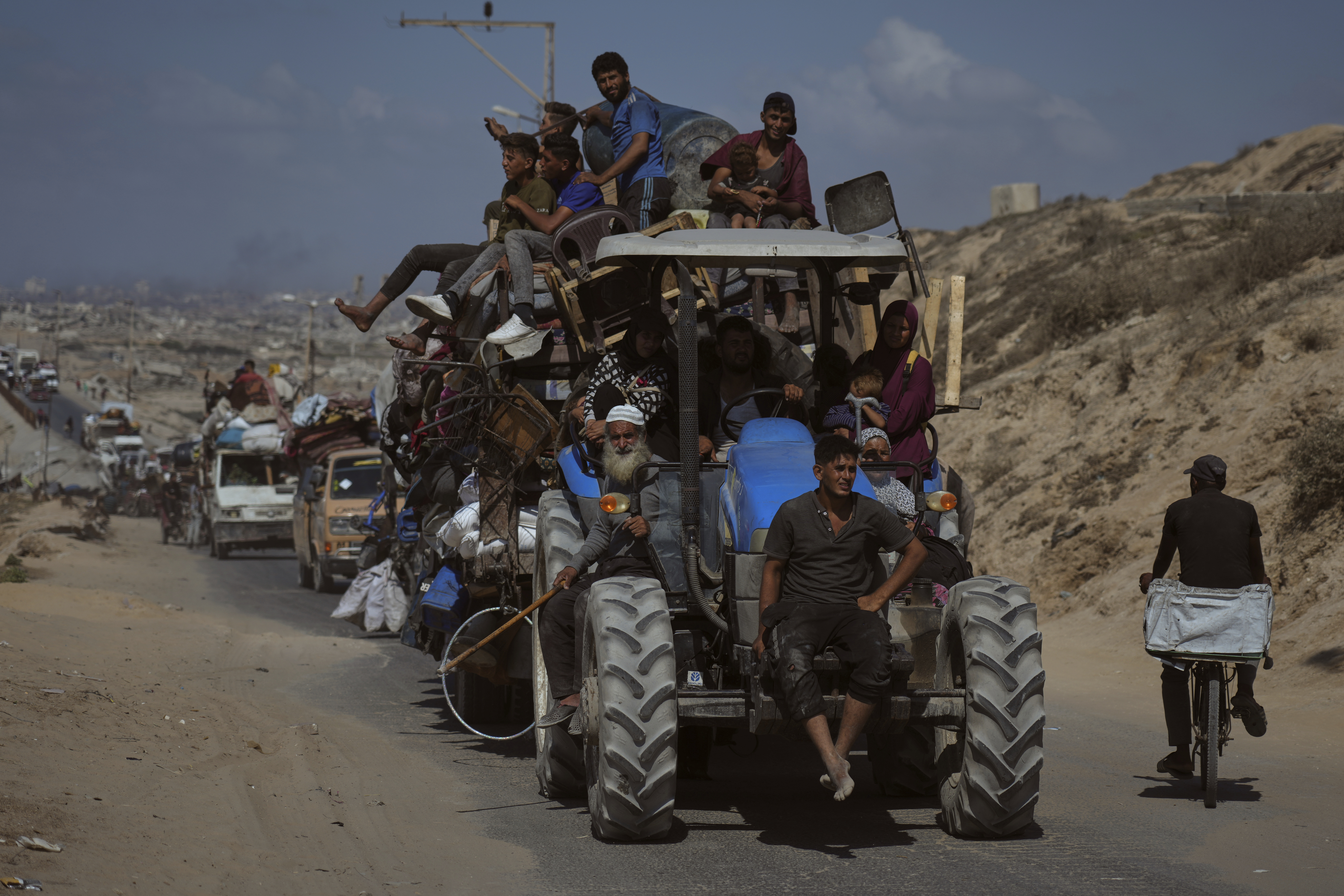 Displaced Palestinians fleeing northern Gaza carry their belongings along the coastal road toward southern Gaza, Tuesday, Sept. 9, 2025, after the Israeli army issued evacuation orders from Gaza City. (Jehad Alshrafi - AP)