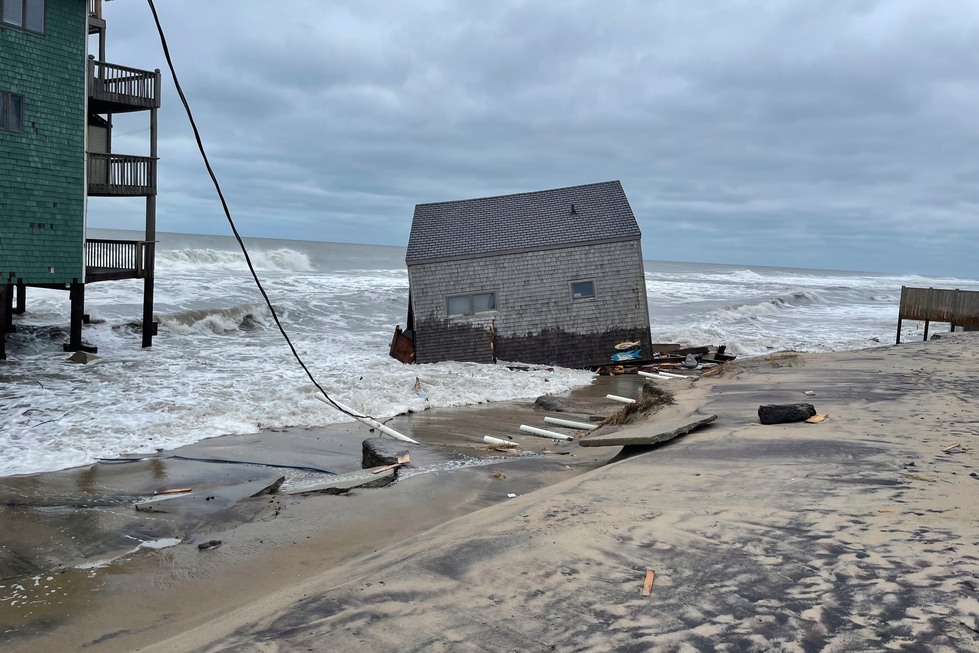 A collapsed beach cottage sits in waves on the shore Tuesday, Sept. 16, 2025, Buxton, NC. (Uncredited - Hatteras National Seashore)