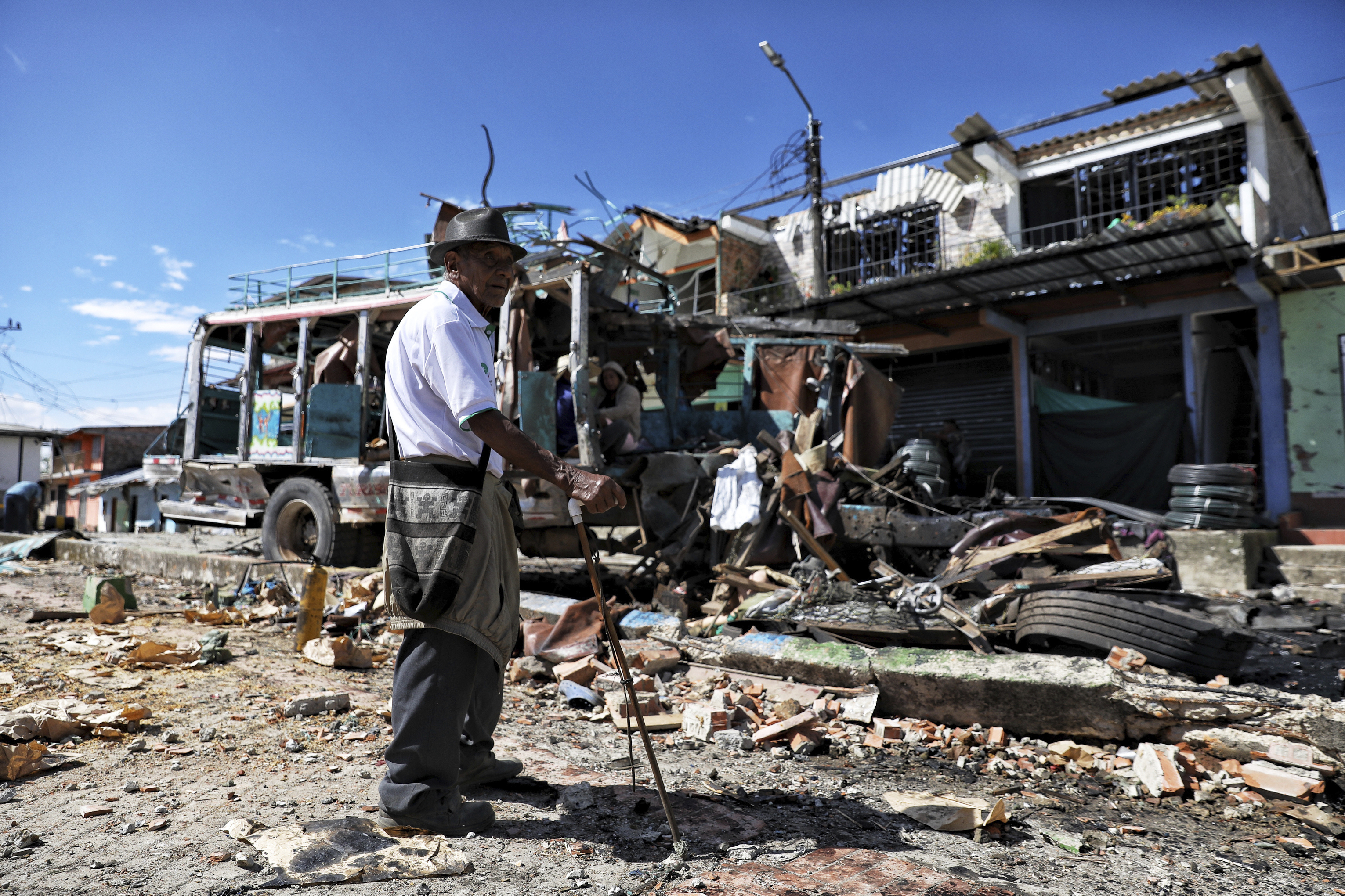 A resident stands in front of the police station in El Carmelo, Colombia, a day after a deadly attack that authorities blame on a dissident faction of the demobilized Revolutionary Armed Forces of Colombia, or FARC, Monday, Sept. 15, 2025.. (Santiago Saldarriaga - AP)