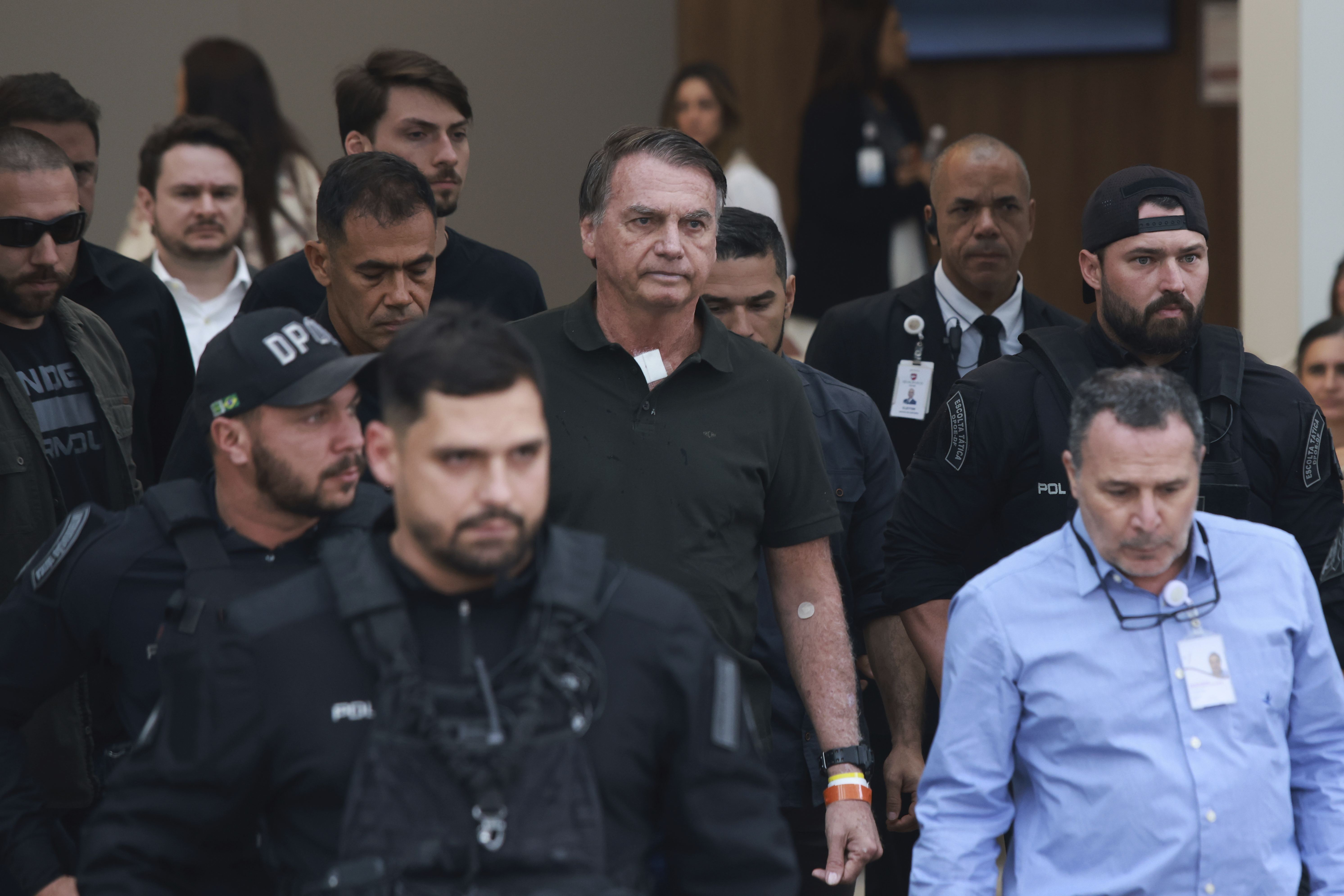 Former President Jair Bolsonaro, center, temporarily allowed out of house arrest for medical treatment, departs a hospital in Brasilia, Brazil, Sunday, Sep. 14, 2025. (Luis Nova - AP)
