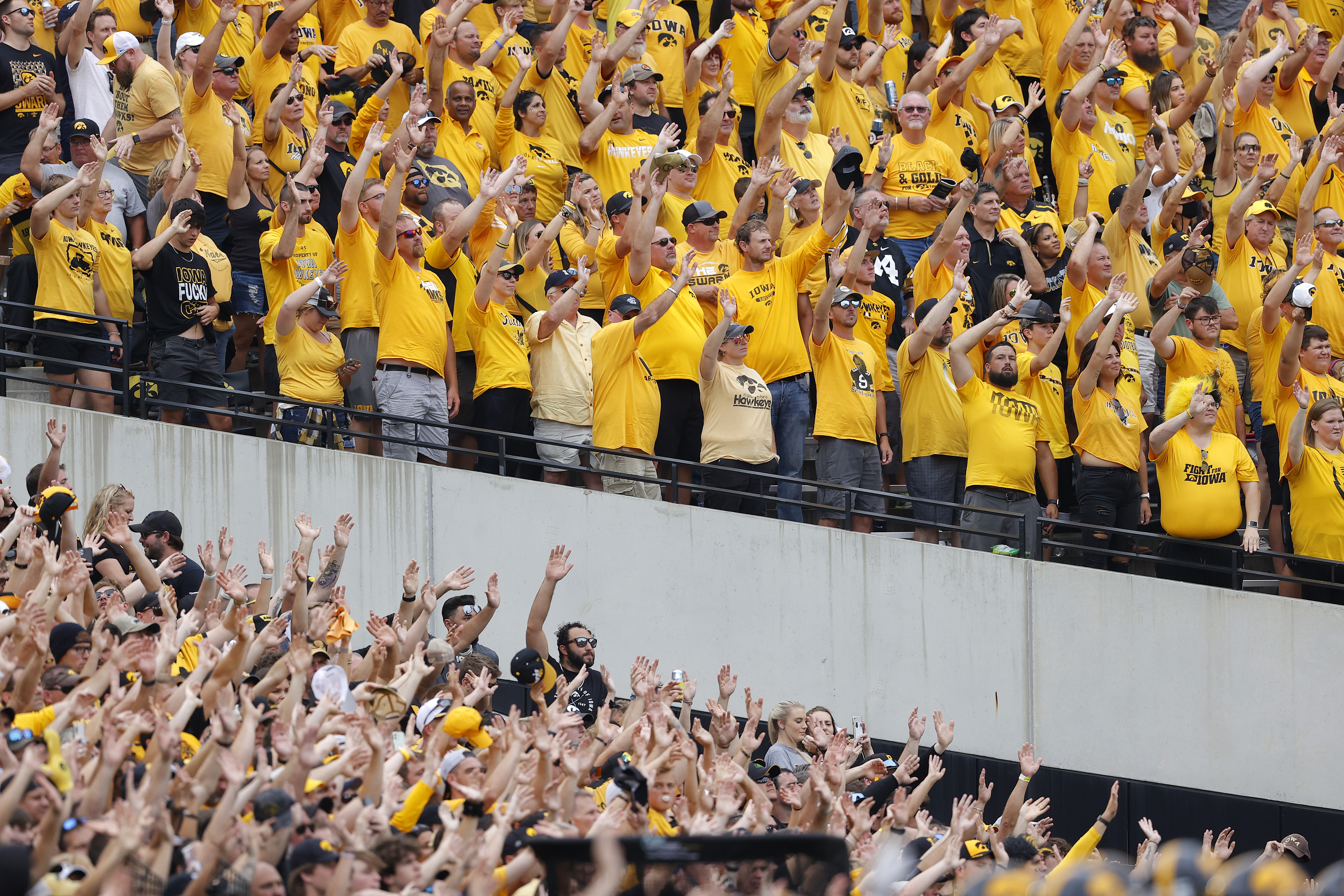 FILE - Iowa fans wave to children in the University of Iowa Stead Family Children's Hospital at the end of the first quarter of an NCAA college football game between Iowa and Penn State, Oct. 9, 2021, in Iowa City, Iowa. (Matthew Putney - FR140274 AP)
