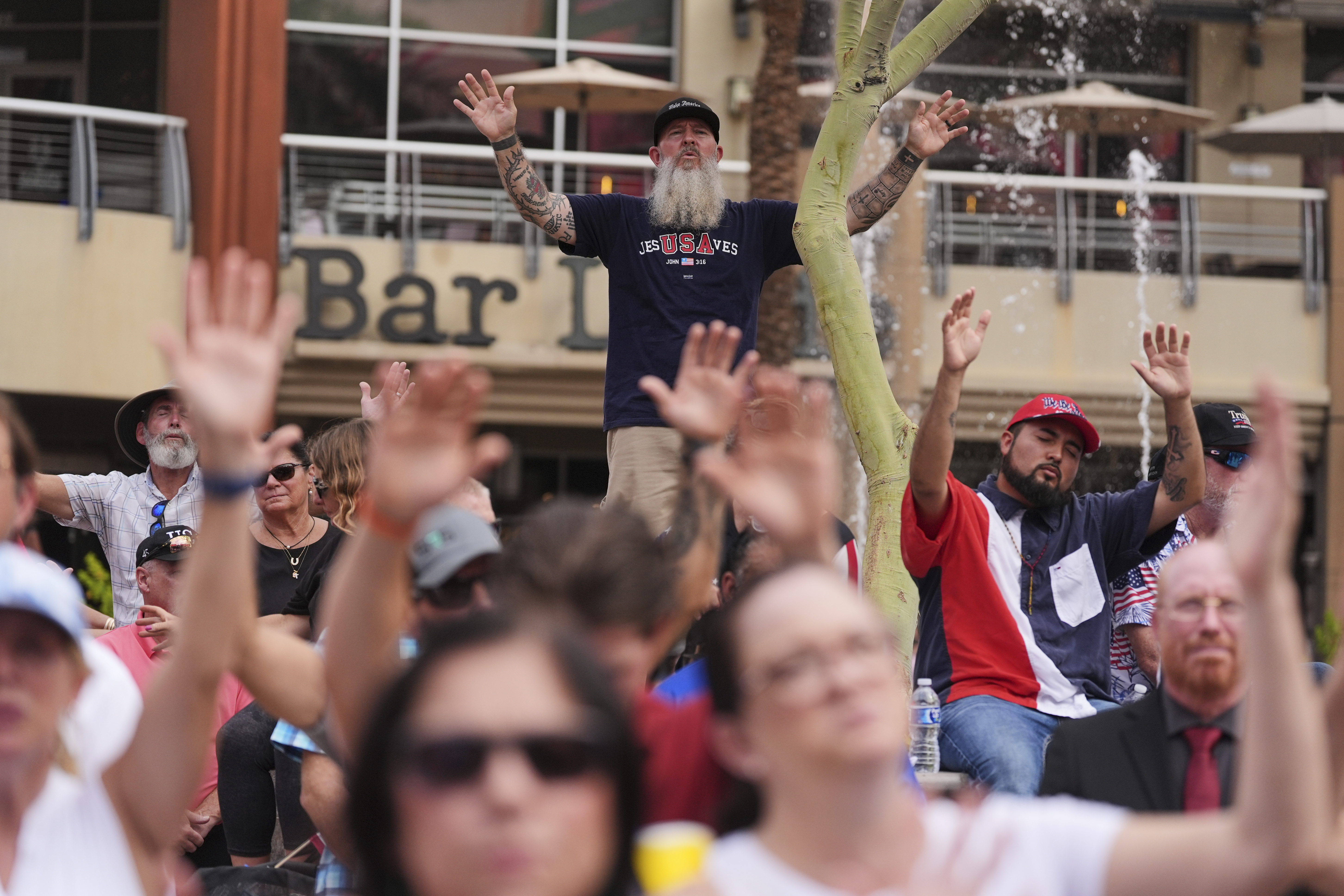 People sing along to a worship song in the overflow area outside before a memorial for conservative activist Charlie Kirk, Sunday, Sept. 21, 2025, at State Farm Stadium in Glendale, Ariz. (Jae C. Hong - AP)