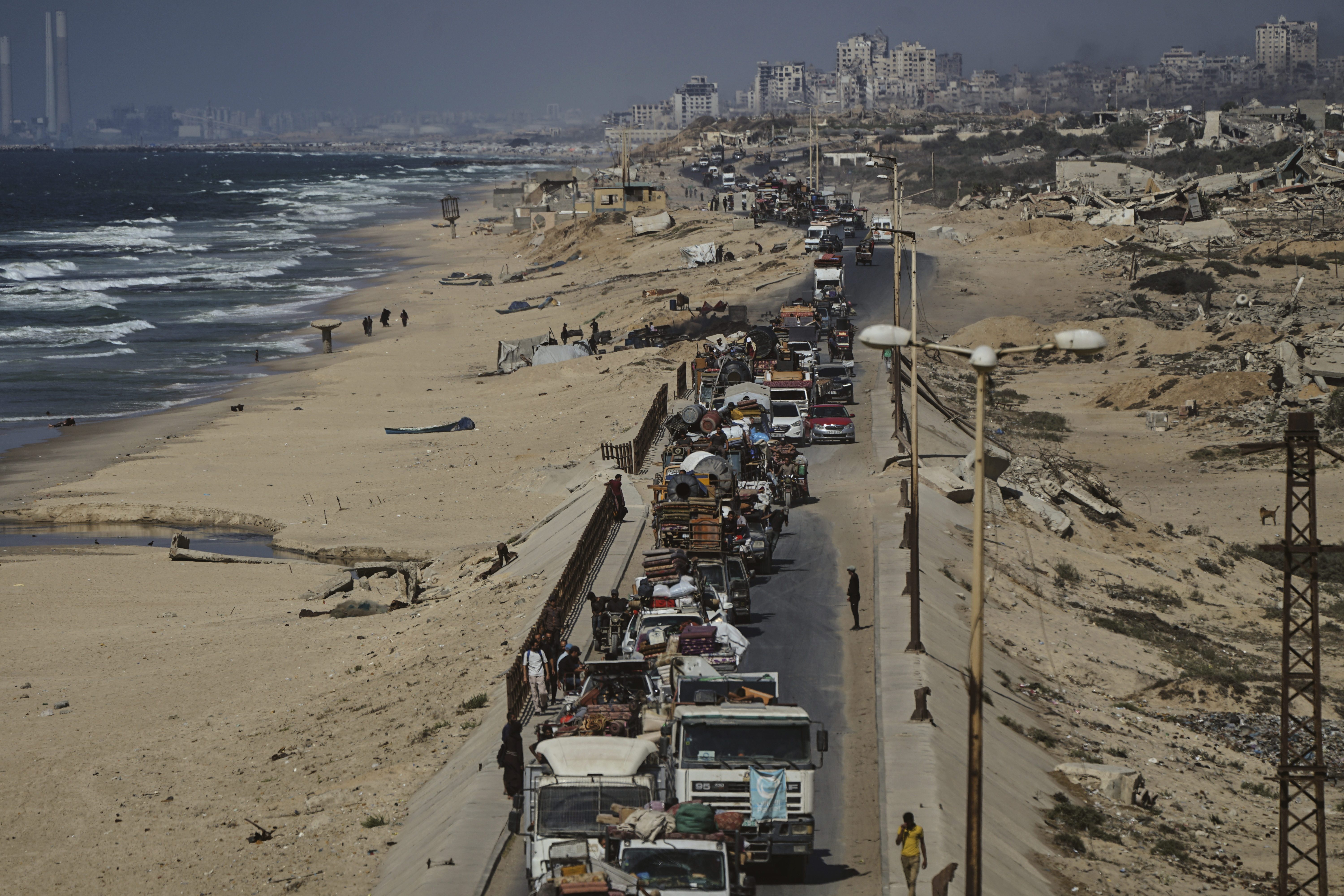 Displaced Palestinians fleeing northern Gaza carry their belongings along the coastal road toward southern Gaza, Tuesday, Sept. 9, 2025, after the Israeli army issued evacuation orders from Gaza City. (Jehad Alshrafi - AP)