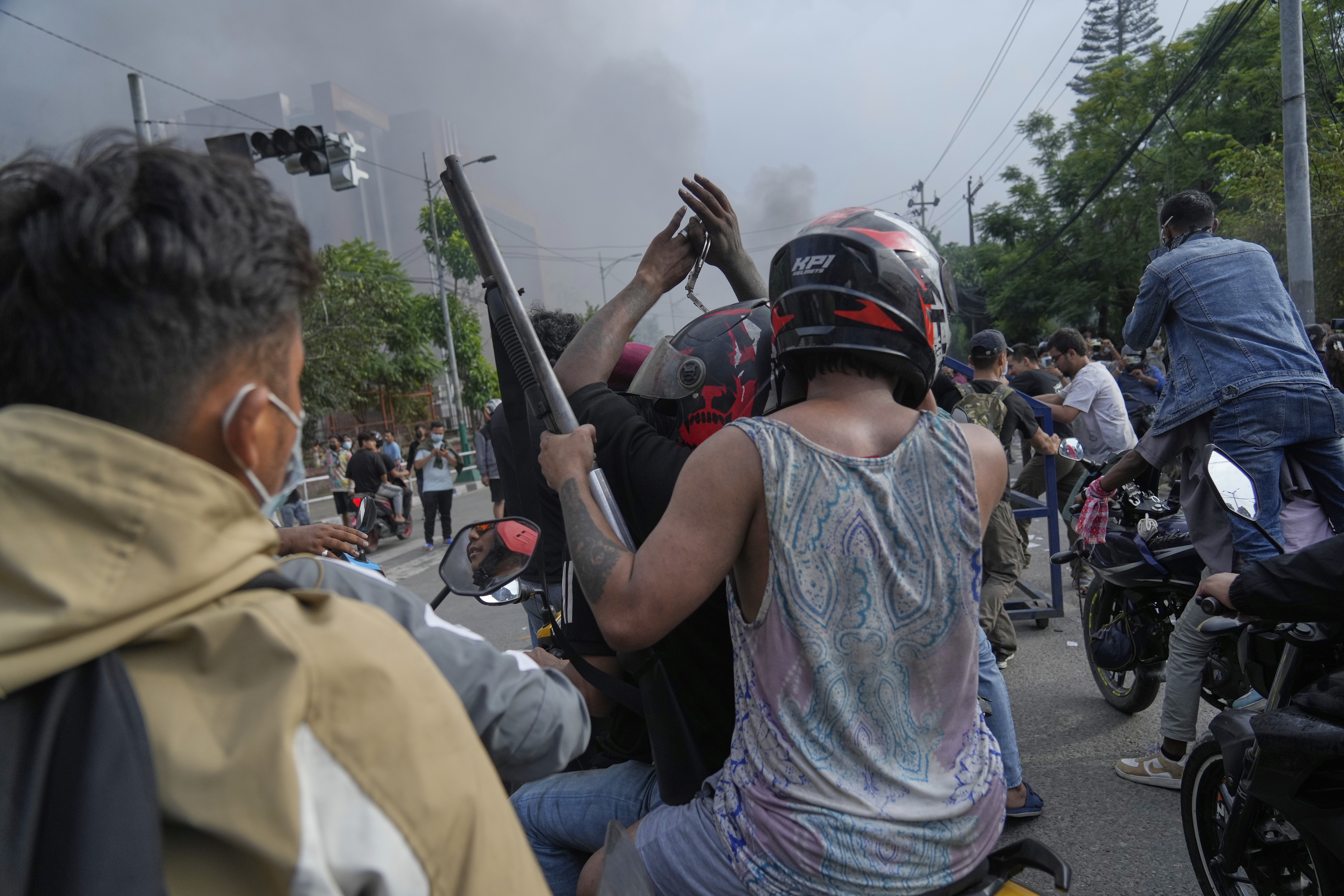 A protester rides on two wheelers carrying a firearm with others during a protest against a social media ban and corruption in Kathmandu, Nepal, Tuesday, Sept. 9, 2025. (Niranjan Shrestha - AP)
