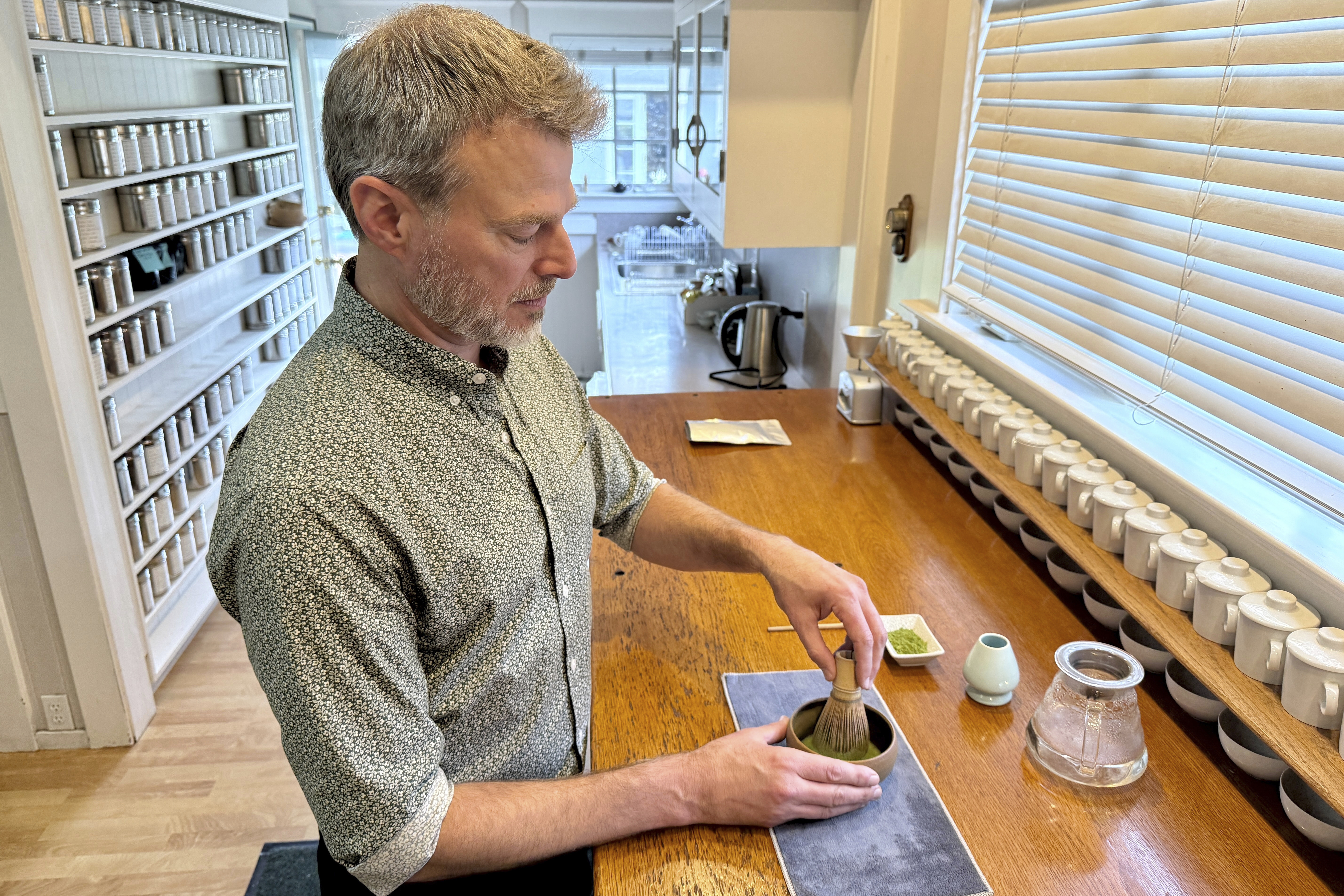 Senior Tea Buyer Aaron Vick uses a whisk to make a matcha drink inside The G.S. Haly Company's tea tasting room in Redwood City, Calif., Wednesday, Sept. 10, 2025. (Haven Daley - AP)