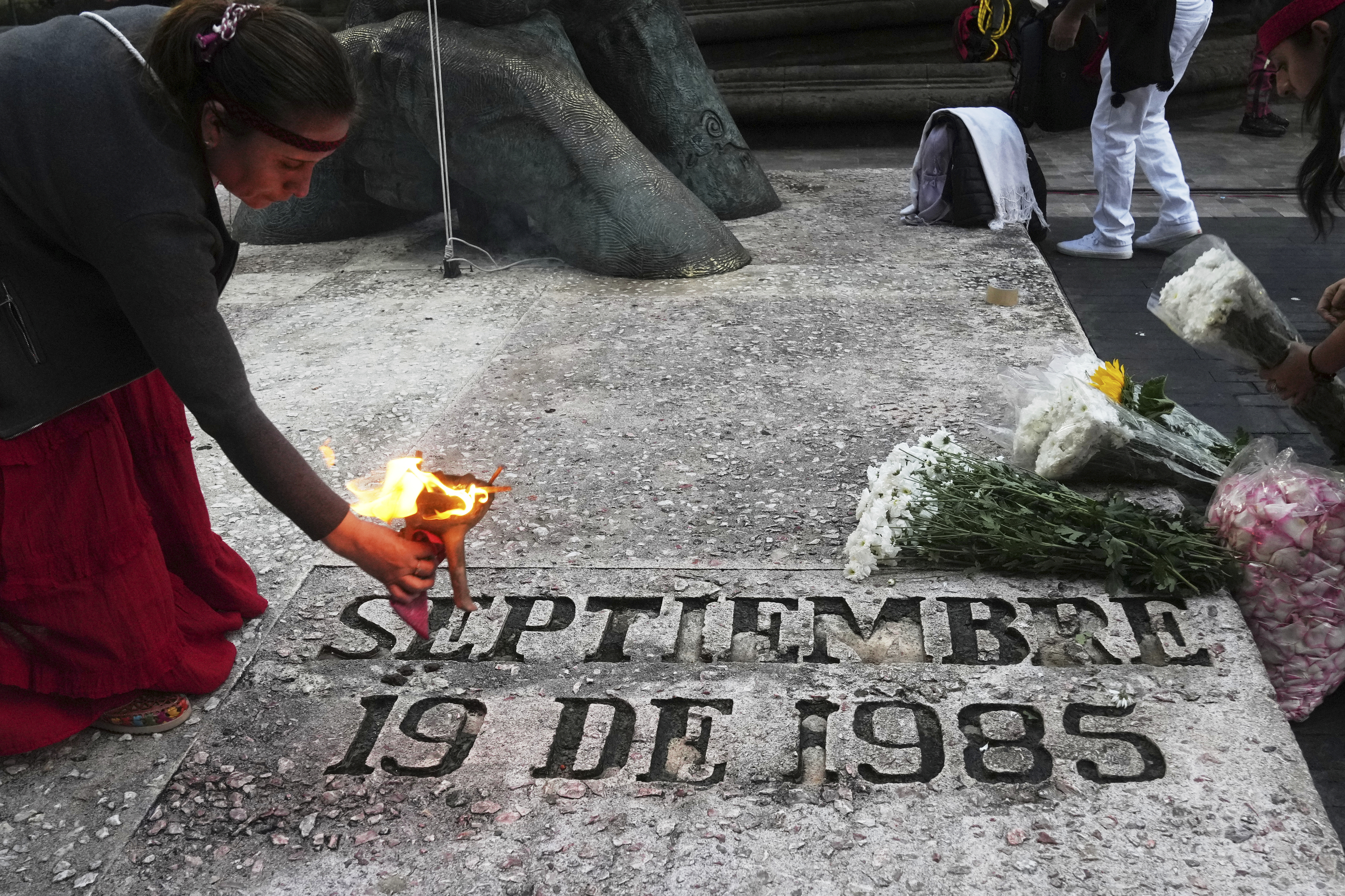 An Indigenous woman uses incense for a blessing at the 1985 earthquake memorial during a ceremony marking the quake's 40th anniversary in Mexico City, Friday, Sept. 19, 2025. (Marco Ugarte - AP)