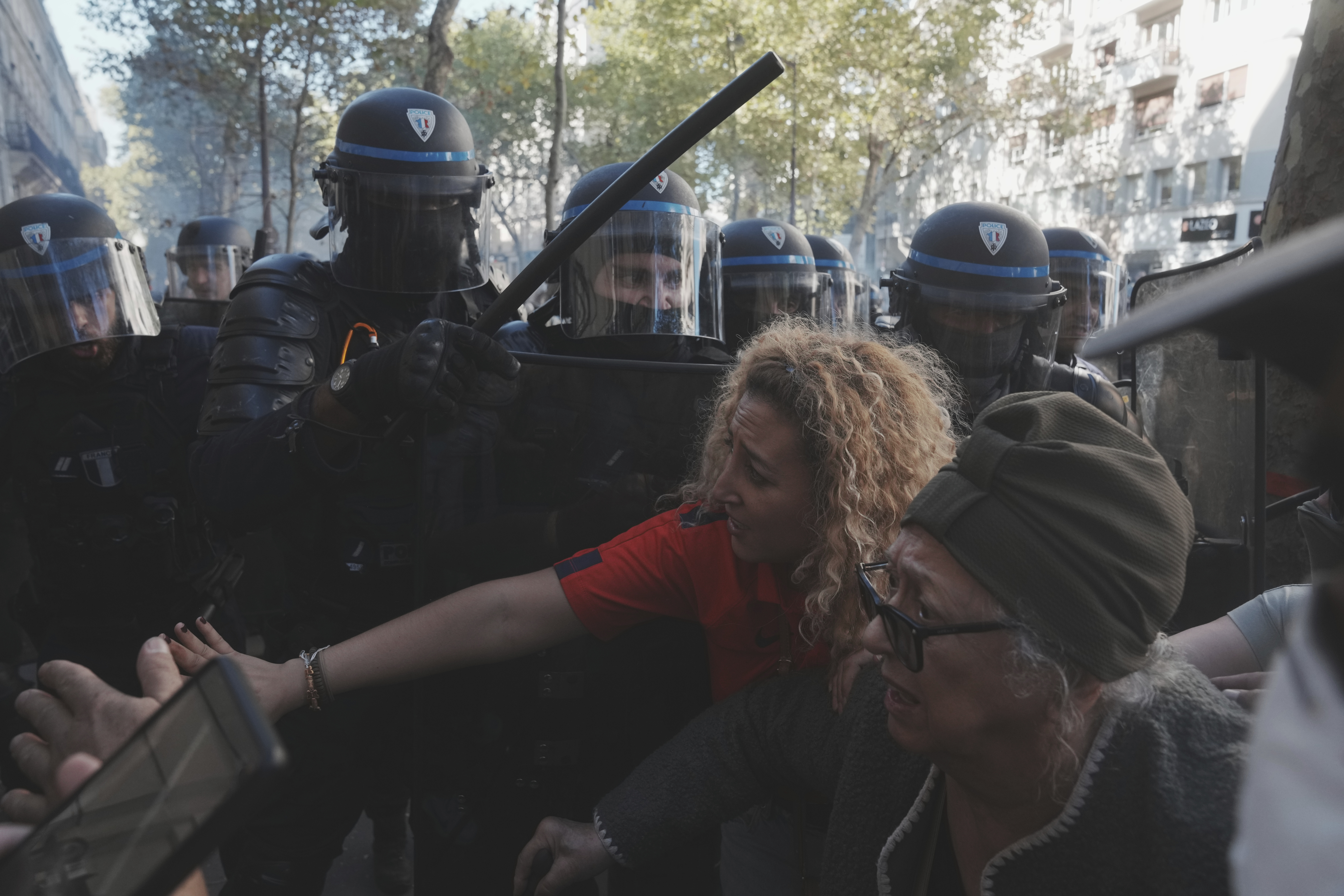 Police officers face protesters during a demonstration called by major trade unions to oppose budget cuts, in Paris, France, Thursday, Sept. 18, 2025. (Thibault Camus - AP)