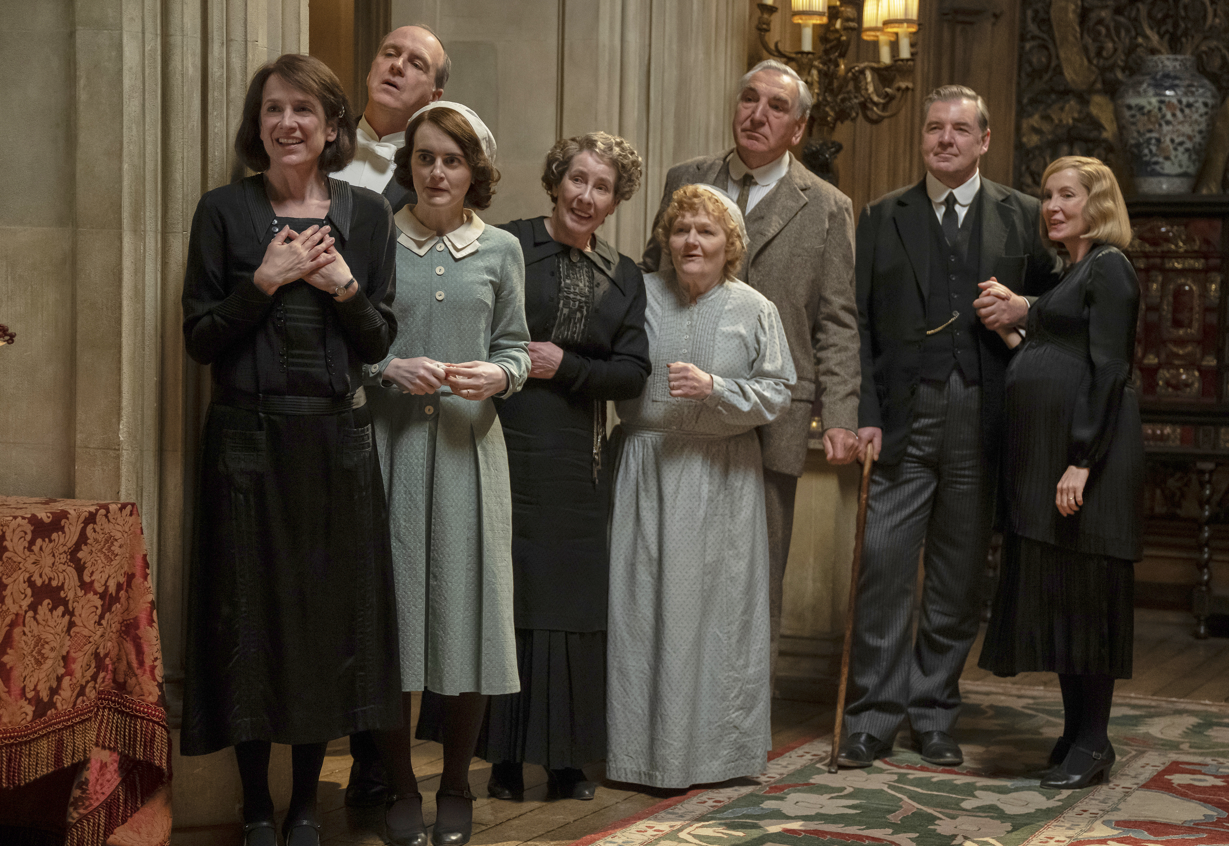 This image released by Focus Features shows Raquel Cassidy, from left, Kevin Doyle, Sophie McShera, Phyllis Logan, Lesley Nicol, Jim Carter, Brendan Coyle and Joanne Froggatt in a scene from