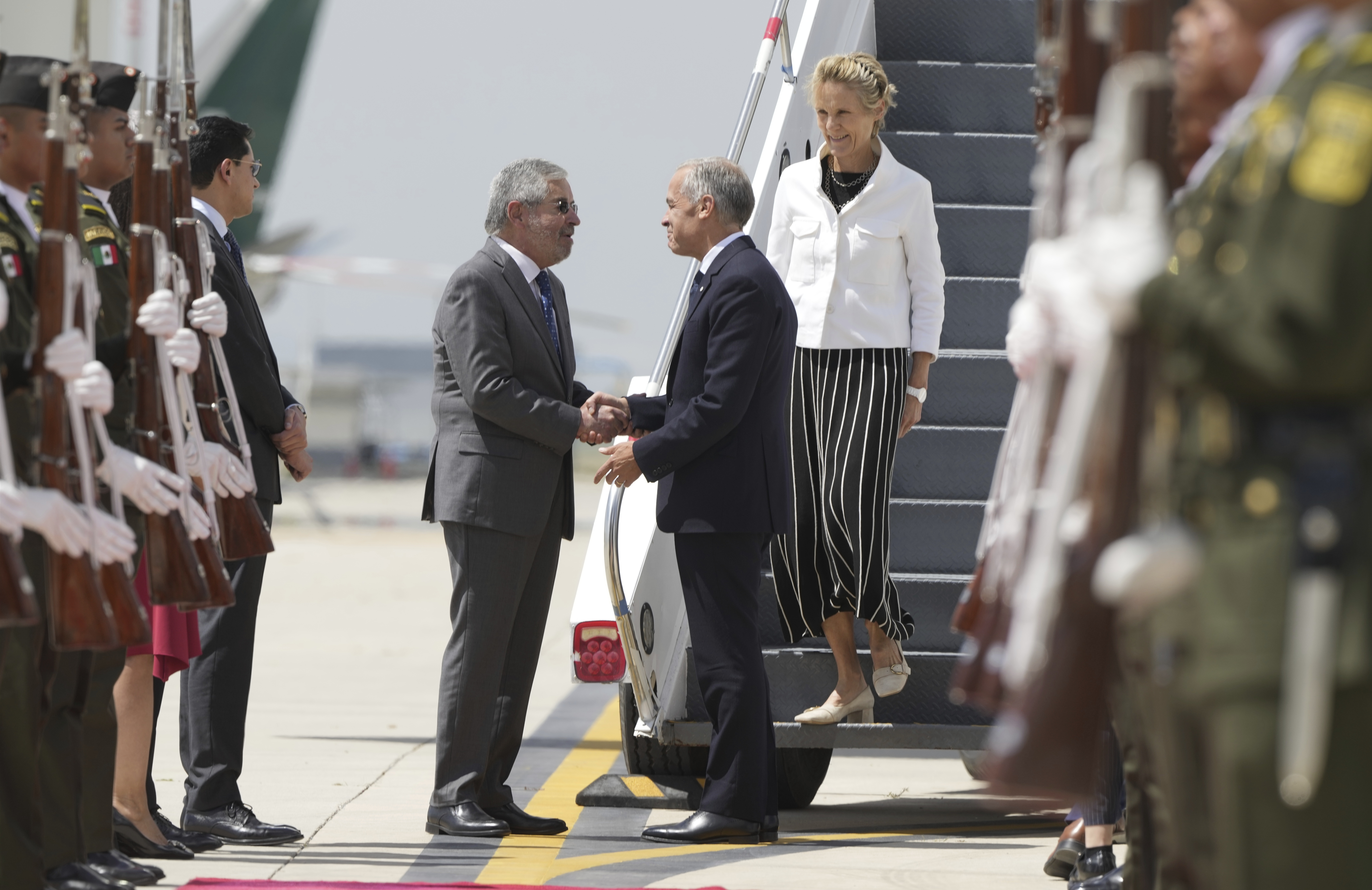 Canada's Prime Minister Mark Carney and his wife Diana Fox Carney are greeted by Mexican Secretary of Foreign Affairs Juan Ramon de la Fuente as they arrive in Mexico City, Thursday, Sept. 18, 2025. (Adrian Wyld - The Canadian Press)