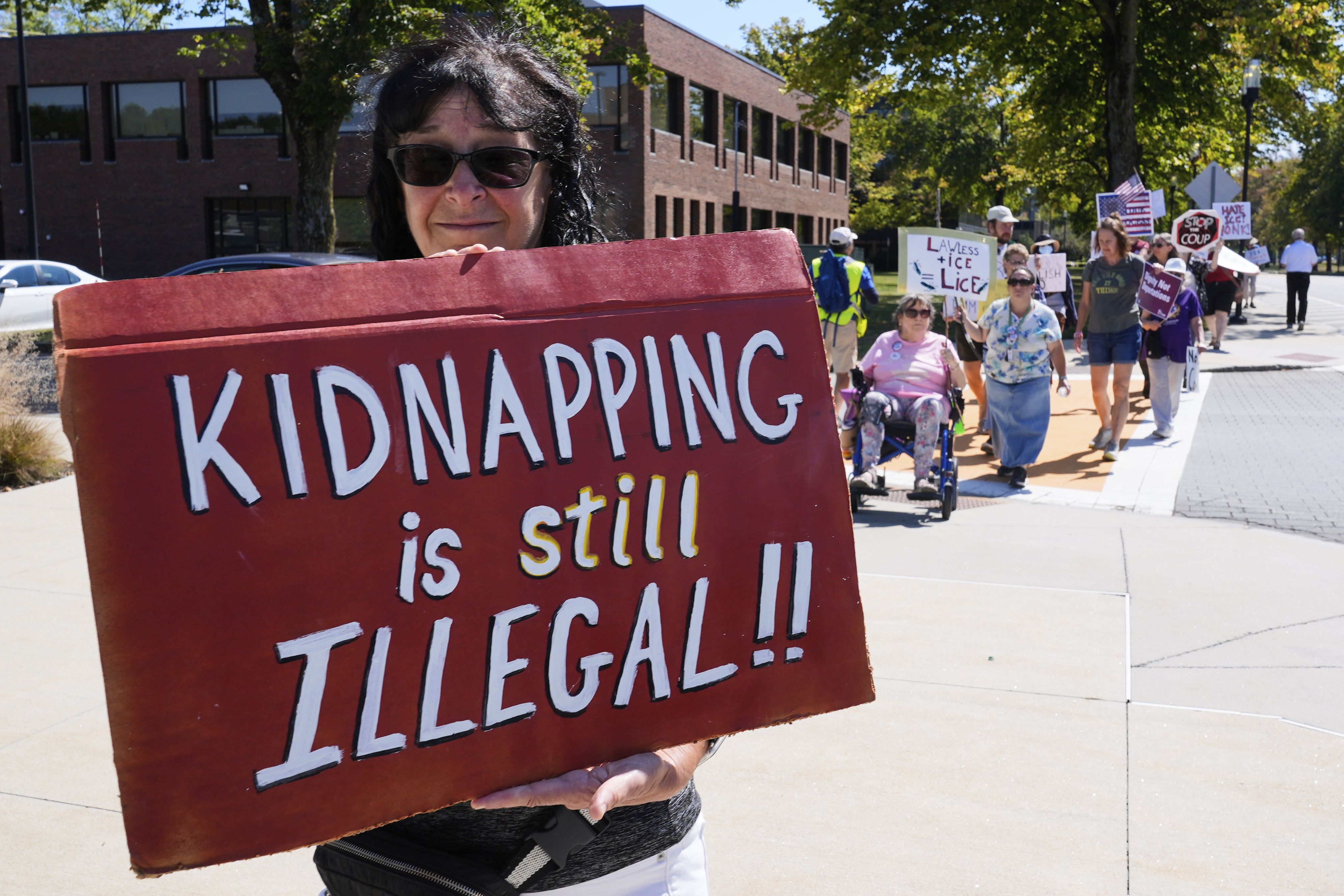 Protesters picket near the U.S. Immigration and Customs Enforcement regional field office, Thursday, Sept. 11, 2025, in Burlington, Mass. (Charles Krupa - AP)