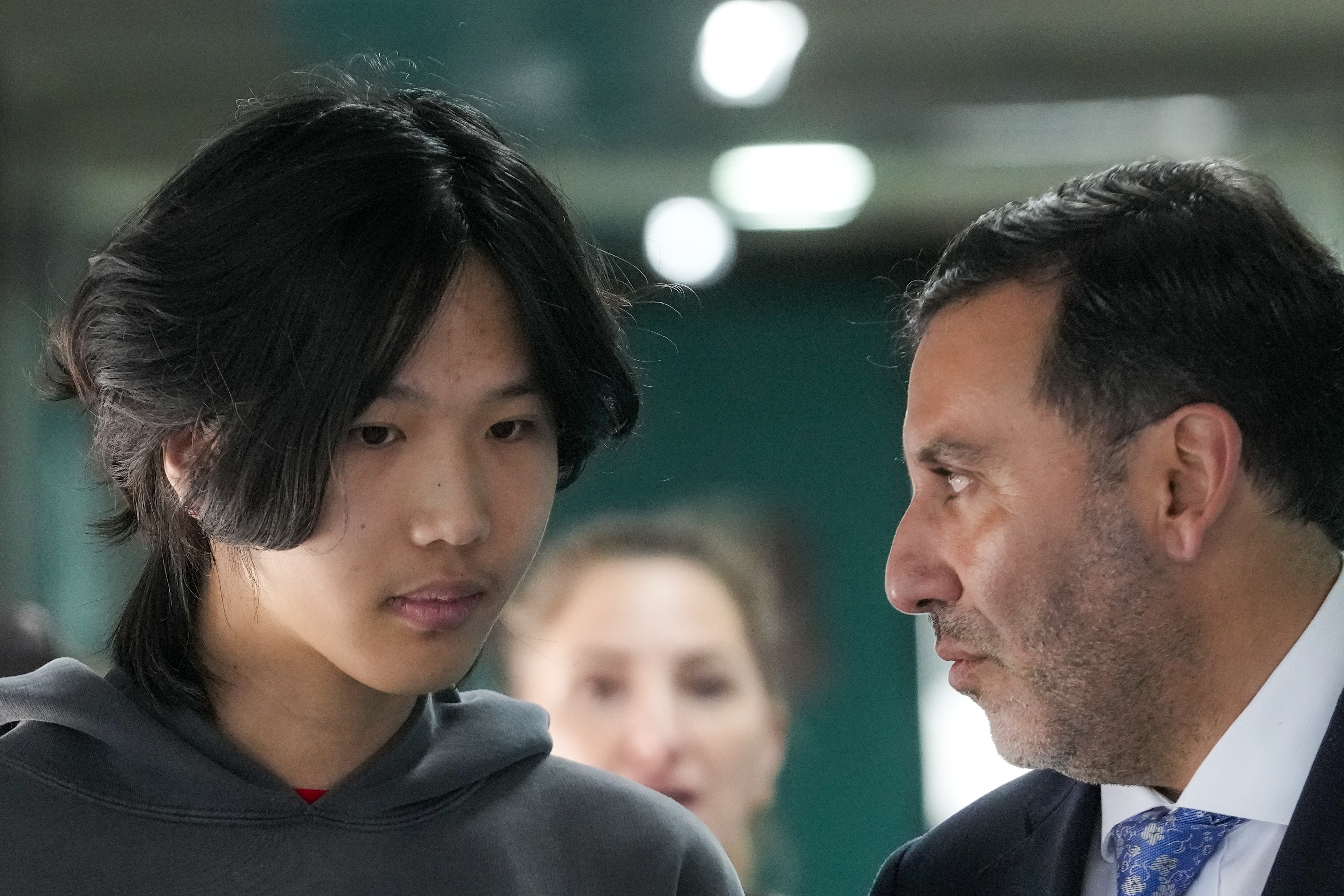 U.S. influencer Ethan Guo, left, talks with his lawyer Jaime Barrientos prior to an event for his donation to children's cancer rehabilitation programs in Santiago, Chile, Tuesday, Sept. 9, 2025. (Esteban Felix - AP)