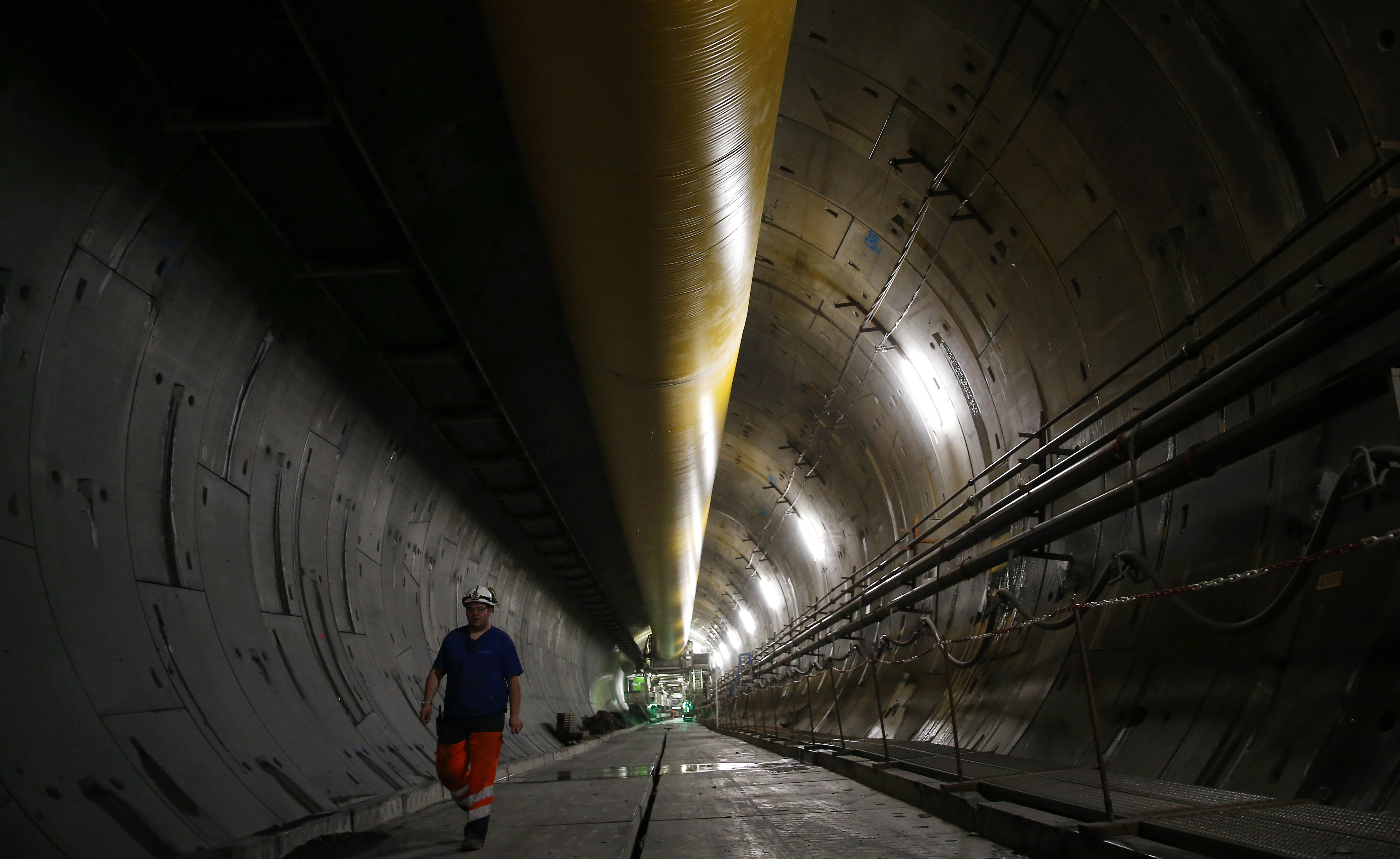 FILE - An engineer walks inside a Turin-Lyon high-speed rail tunnel (TAV) in Saint Martin La Porte, France, Feb. 12, 2019. (Antonio Calanni - AP)