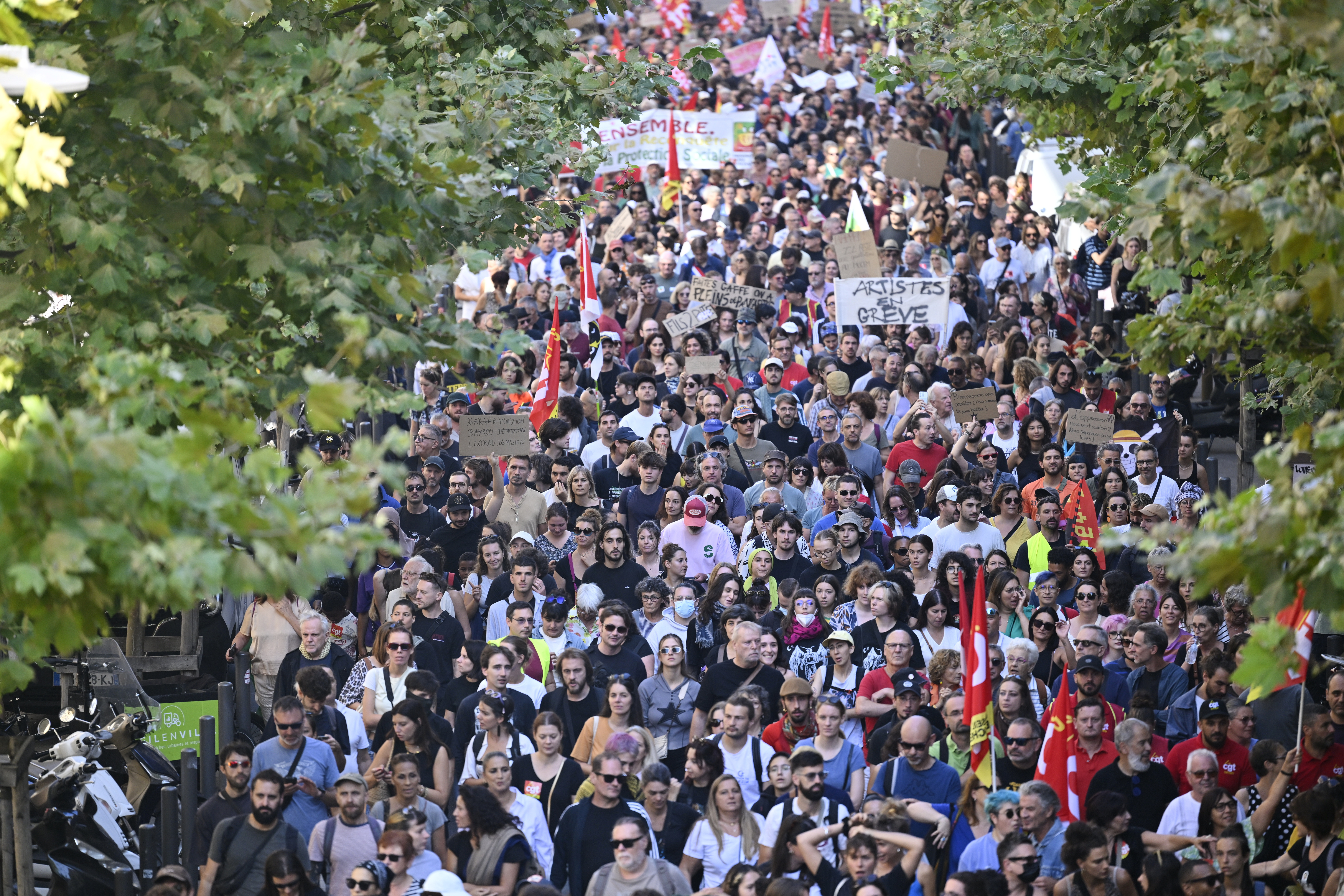 FILE- Protesters march during a rally of the