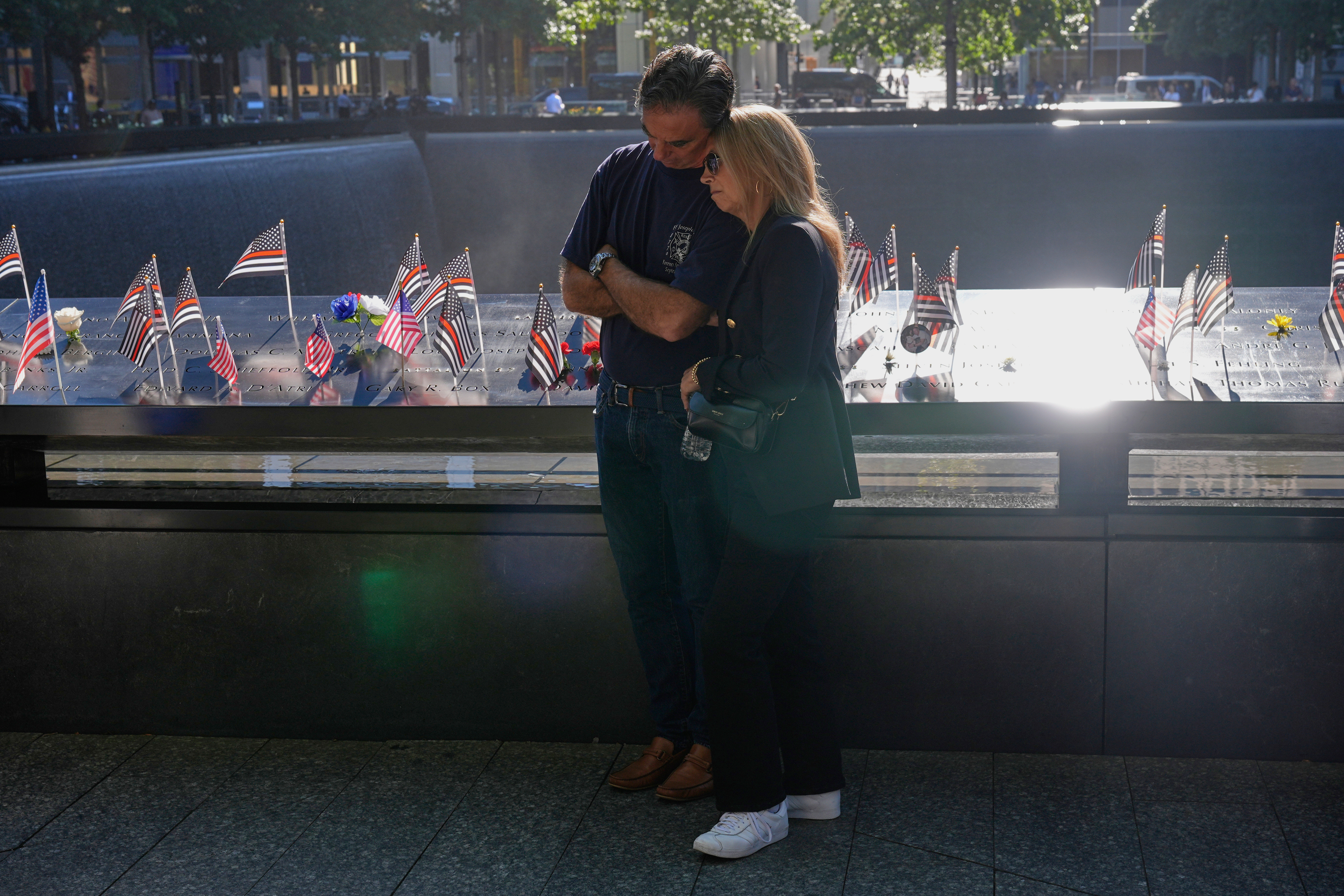 People bow their heads during a moment of silence during a ceremony to mark the 24th anniversary of the 9/11 attacks, Thursday, Sept. 11, 2025, in New York. (Seth Wenig - AP)