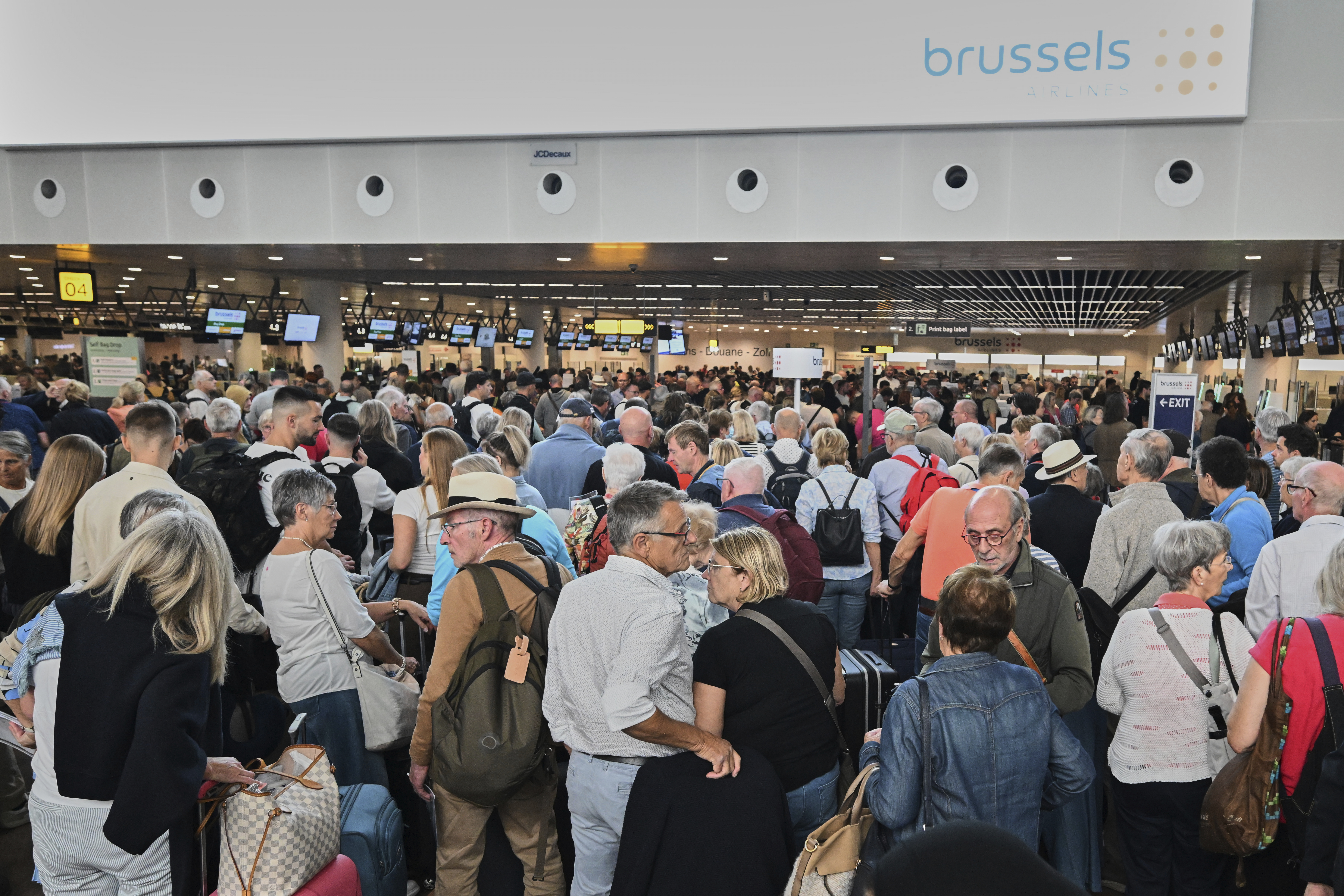 People stand in a line to check in after a cyber attack caused delays at Brussels International Airport in Zaventem, Belgium, Saturday, Sept. 20, 2025. (Harry Nakos - AP)