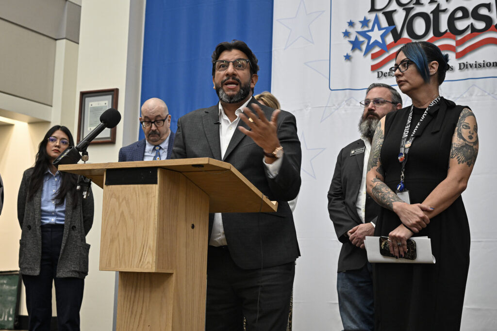 a denver city official speaks at a podium