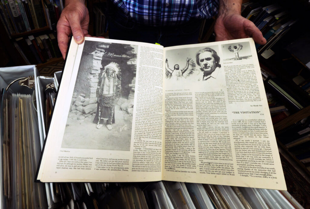 In the “El Paso County Colorado Heritage” book, Bob DeWitt opens to a page showing Chief Manitou at his “Secret Bookshop” in Fountain on Tuesday, Oct. 7, 2025. (The Gazette, Jerilee Bennett)