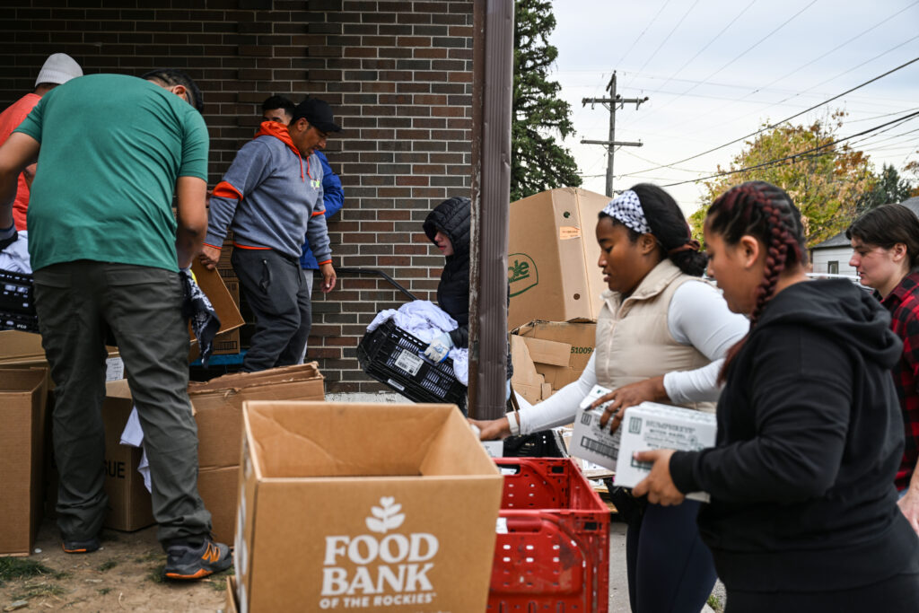 Volunteers help unload 50 pallets at Village Exchange Center on Friday, Oct. 31, 2025. The center will open its food bank an extra day and for longer hours in preparation for the possible lapse in SNAP benefits in November. (Stephen Swofford, Denver Gazette)
