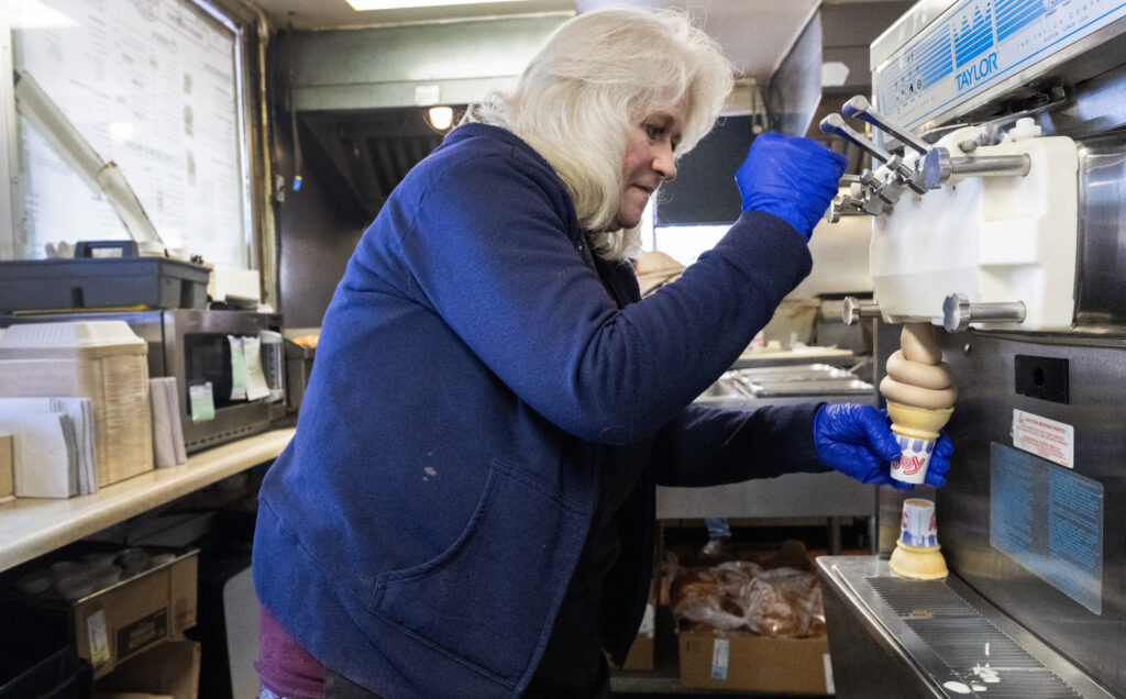 Regina Misurelli, who bought Big Burger World in 1991, pours a soft ice cream cone for a customer on Wednesday, Oct. 29, 2025, at the restaurant in Canon City. (The Gazette, Christian Murdock)