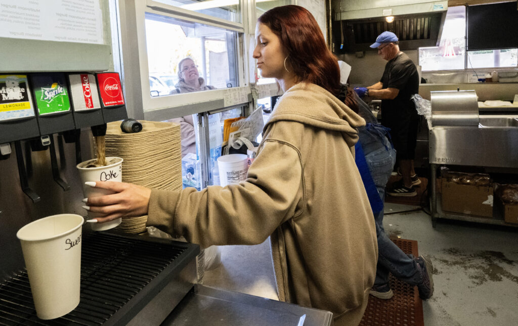 Bree Turner, 19, fills drink orders at the Big Burger World restaurant in Canon City on Wednesday, Oct. 29, 2025. Turner started working at the restaurant three years ago as her first job. She said the staff is like family. (The Gazette, Christian Murdock)
