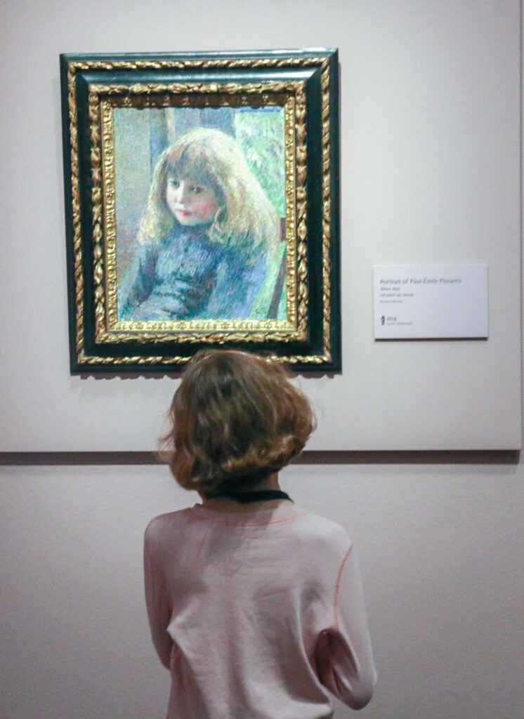 Young Aila Fordham, age 9, of Denver, considers a portrait of Paul-Émile Pissarro, the artist’s son, as a 6-year-old boy. Photo taken Oct. 24, 2025, at the Denver Art Museum. (John Moore, Denver Gazette)