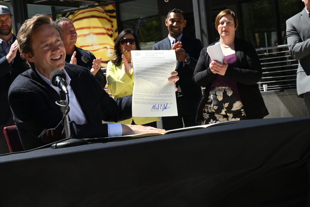 a government official holding up a freshly signed executive order.