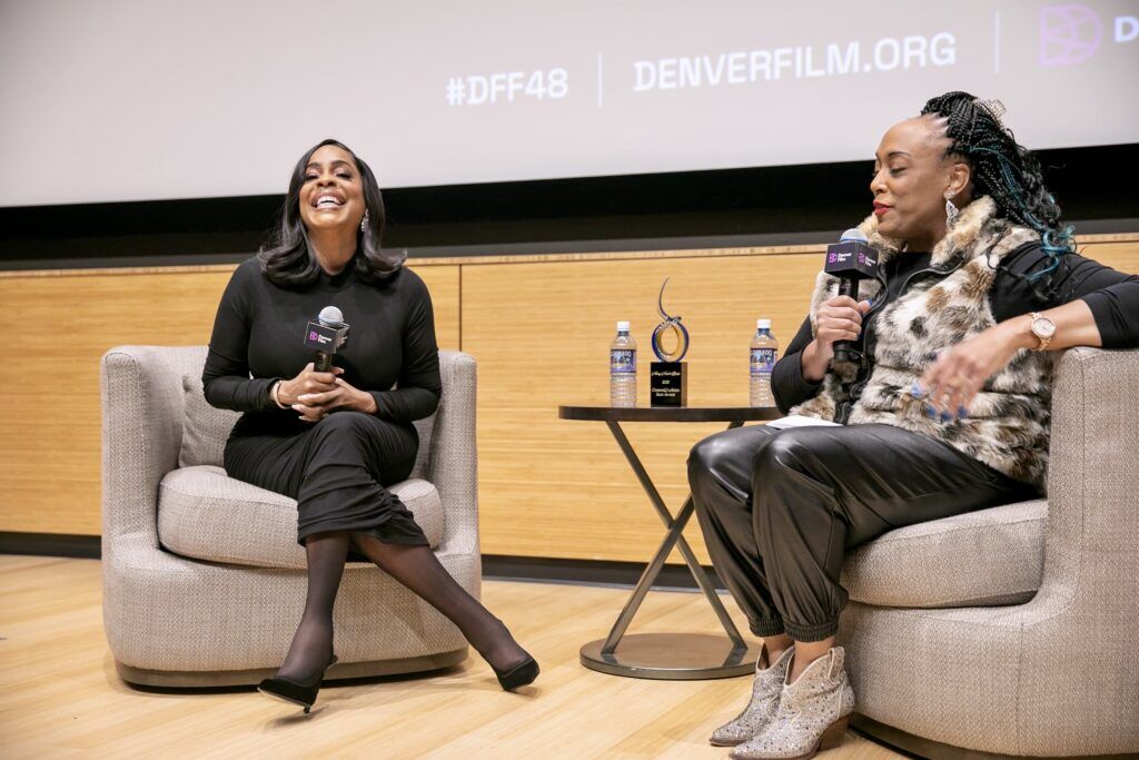 Niecy Nash-Betts talks with radio personality Nikki Swarn after accepting Denver Film’s fourth CinemaQ LaBahn Ikon Award at the Denver Botanic Gardens on Nov. 2, 2025. (Jason DeWitt Denver Film)