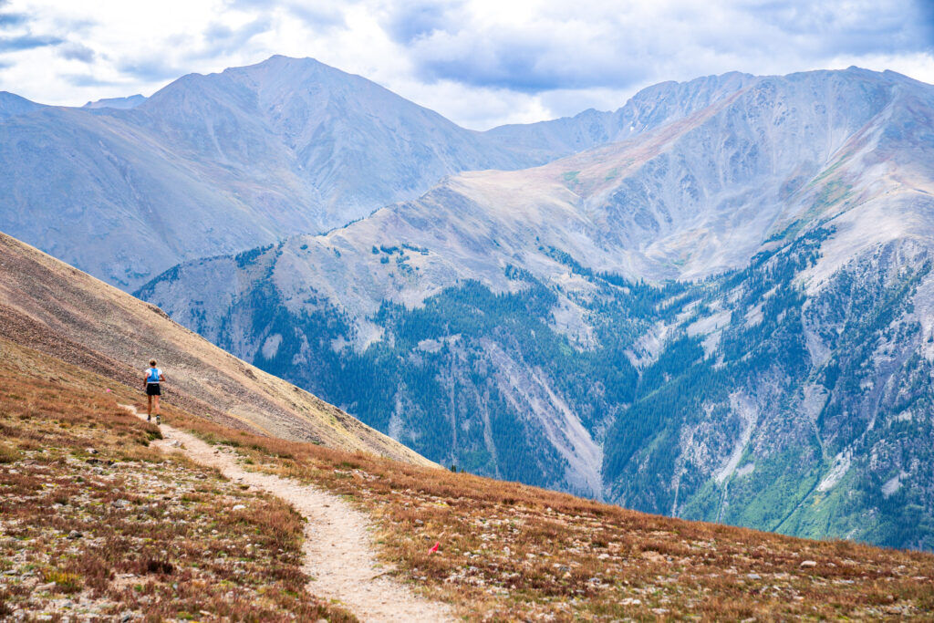 Anne Flower runs across Hope Pass in the mountains above Leadville. Photo by Peter Maksimow