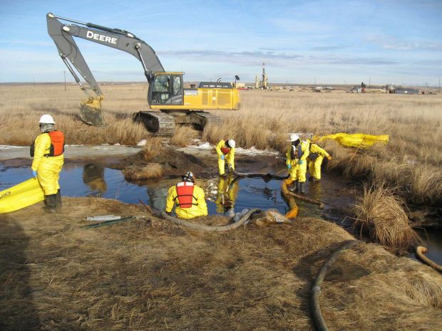 Crews work to recover oil from Blacktail Creek north of Williston in 2015 after a pipeline leak released nearly 3 million gallons of saltwater that included some oil.
